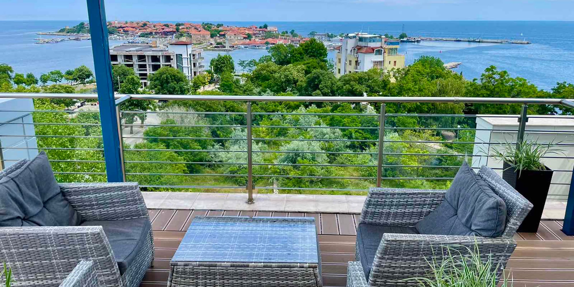 a deck with a view of the ocean and a city