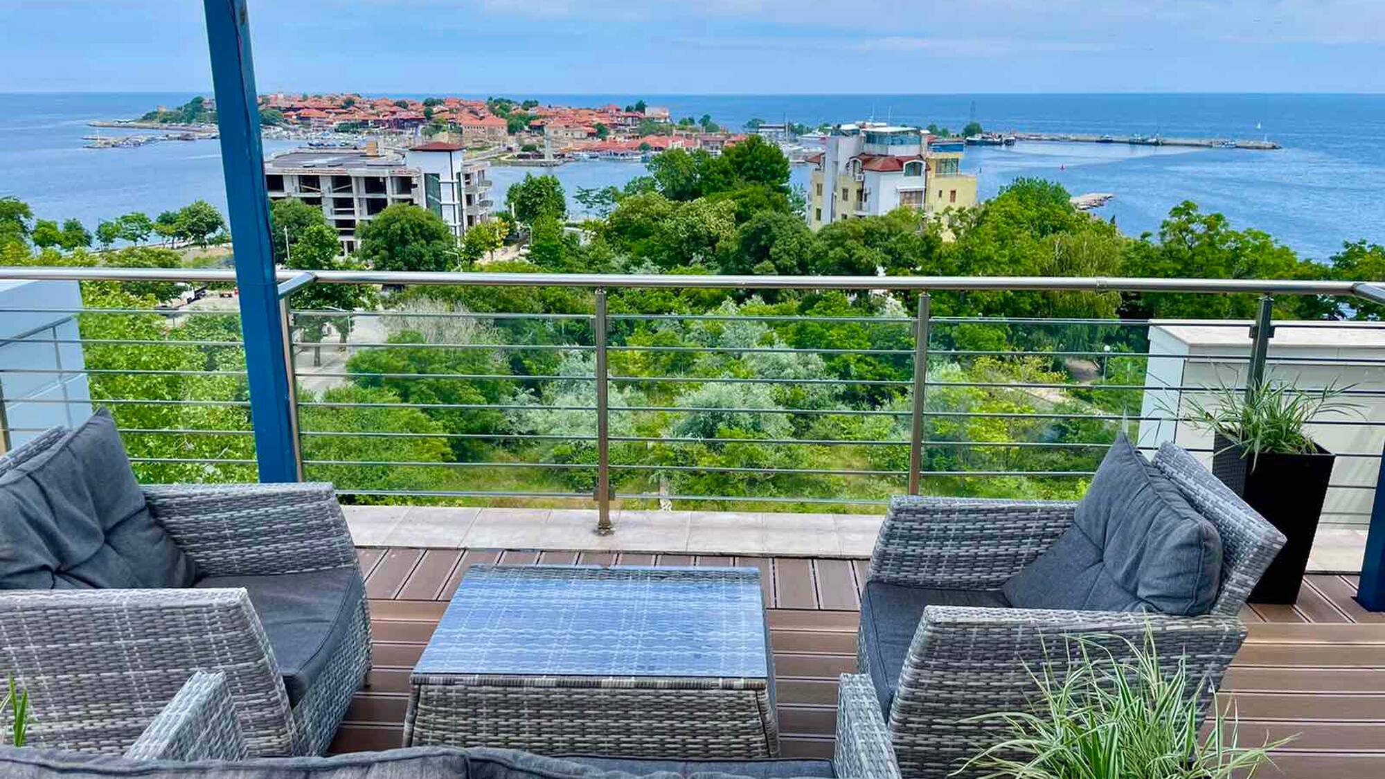 a deck with a view of the ocean and a city