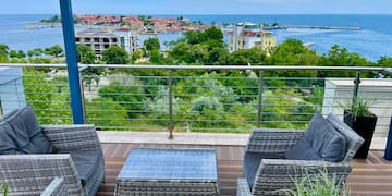 a deck with a view of the ocean and a city