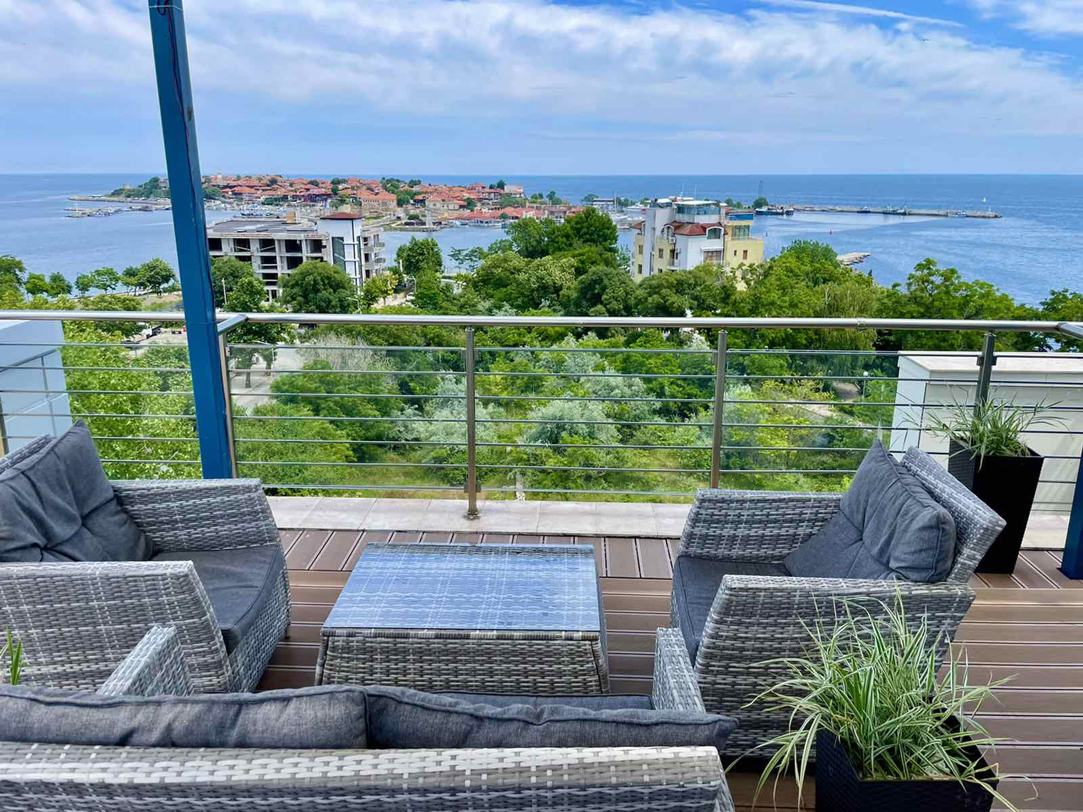 a deck with a view of the ocean and a city