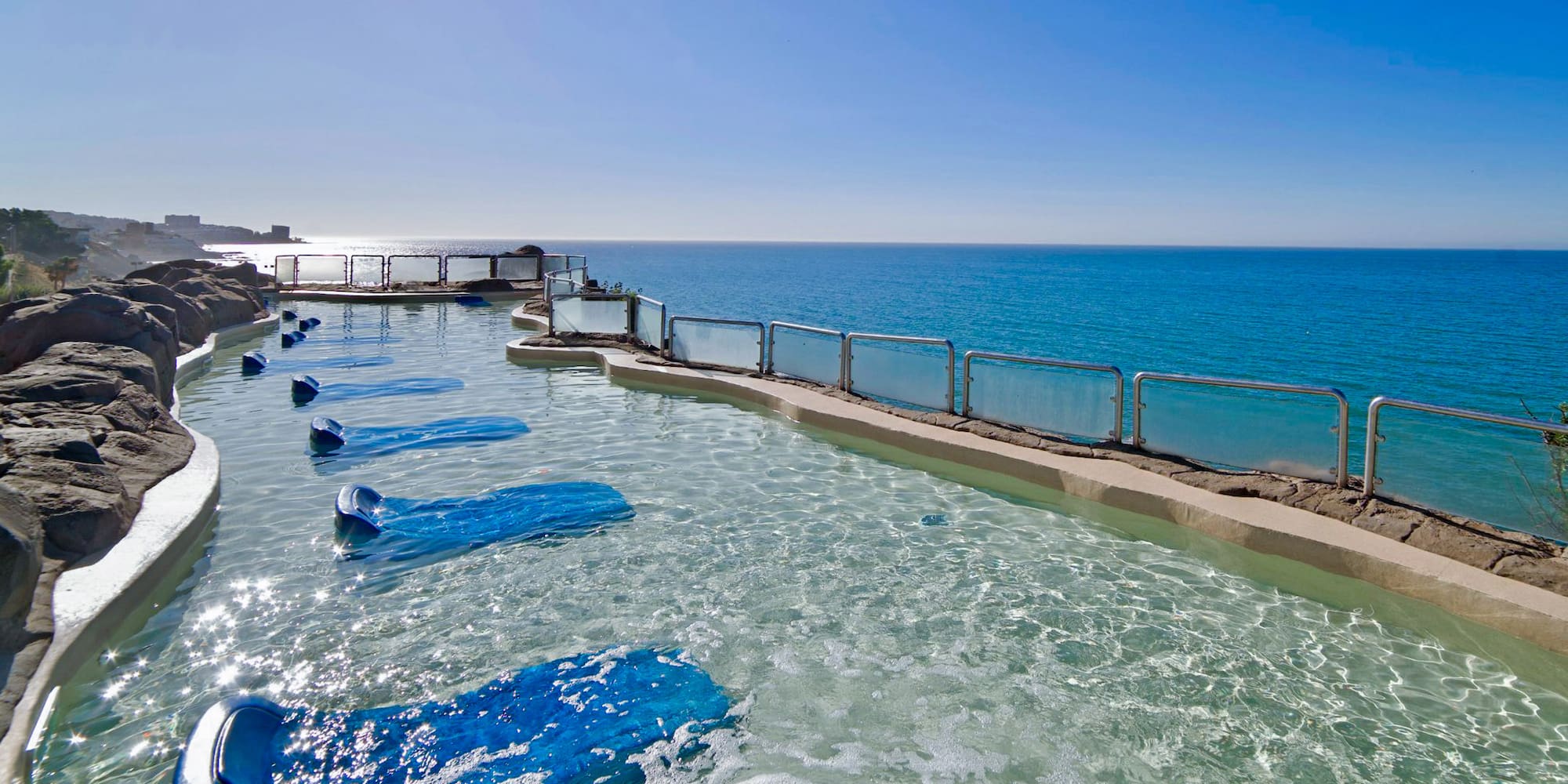 a pool with blue water and blue sky
