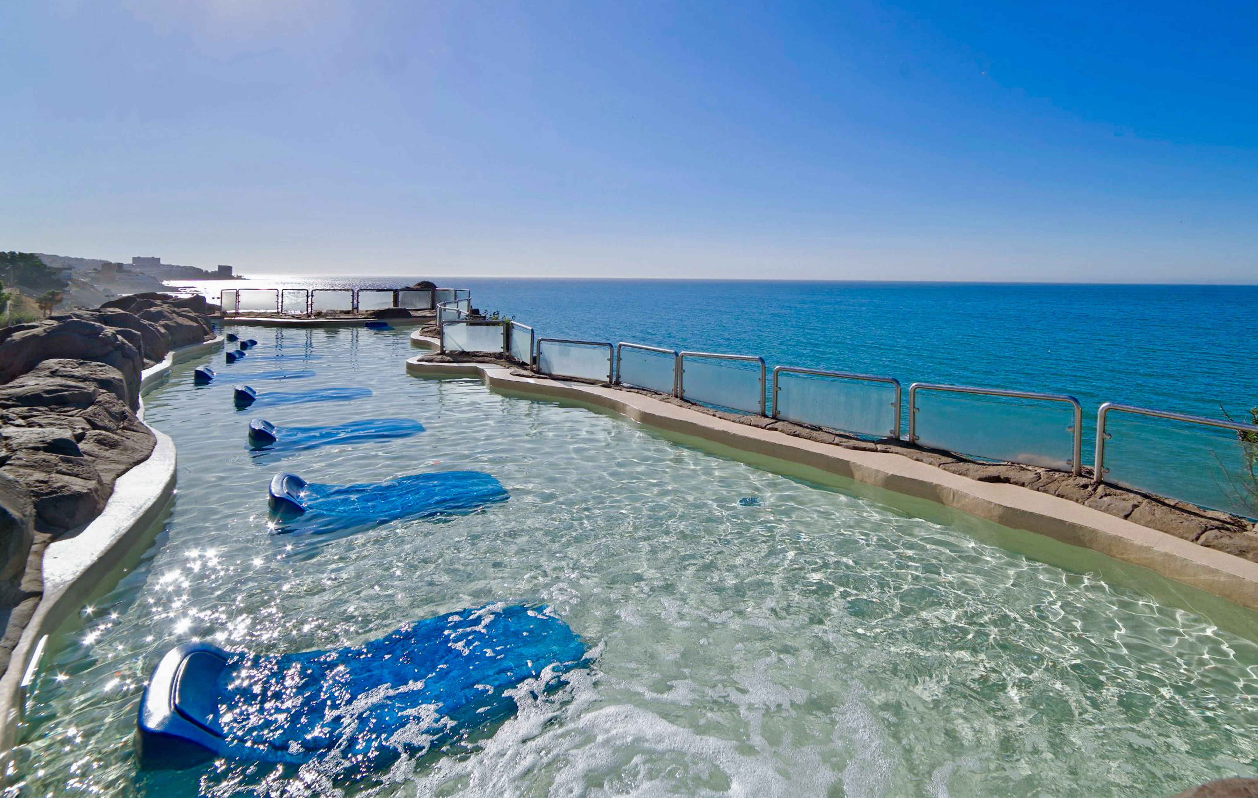 a pool with blue water and blue sky