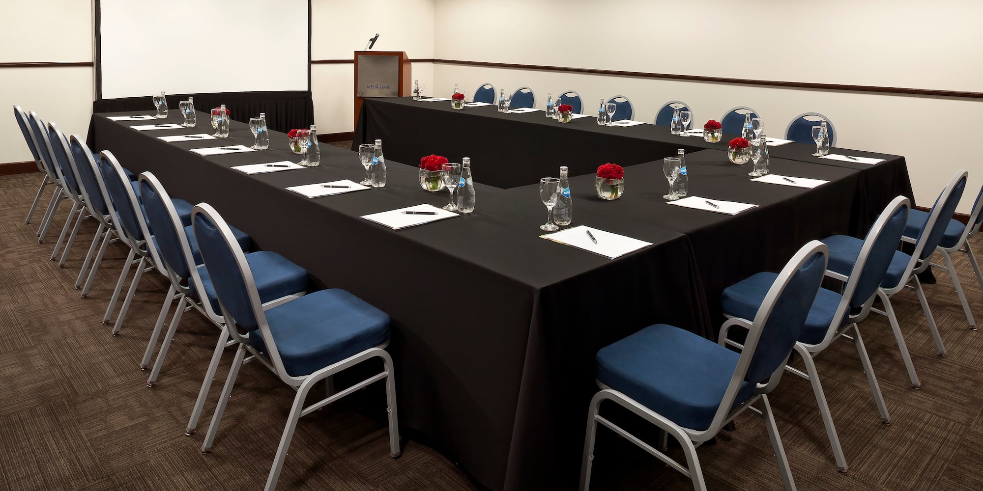 a long conference room with chairs and tables