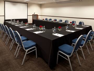 a long conference room with chairs and tables