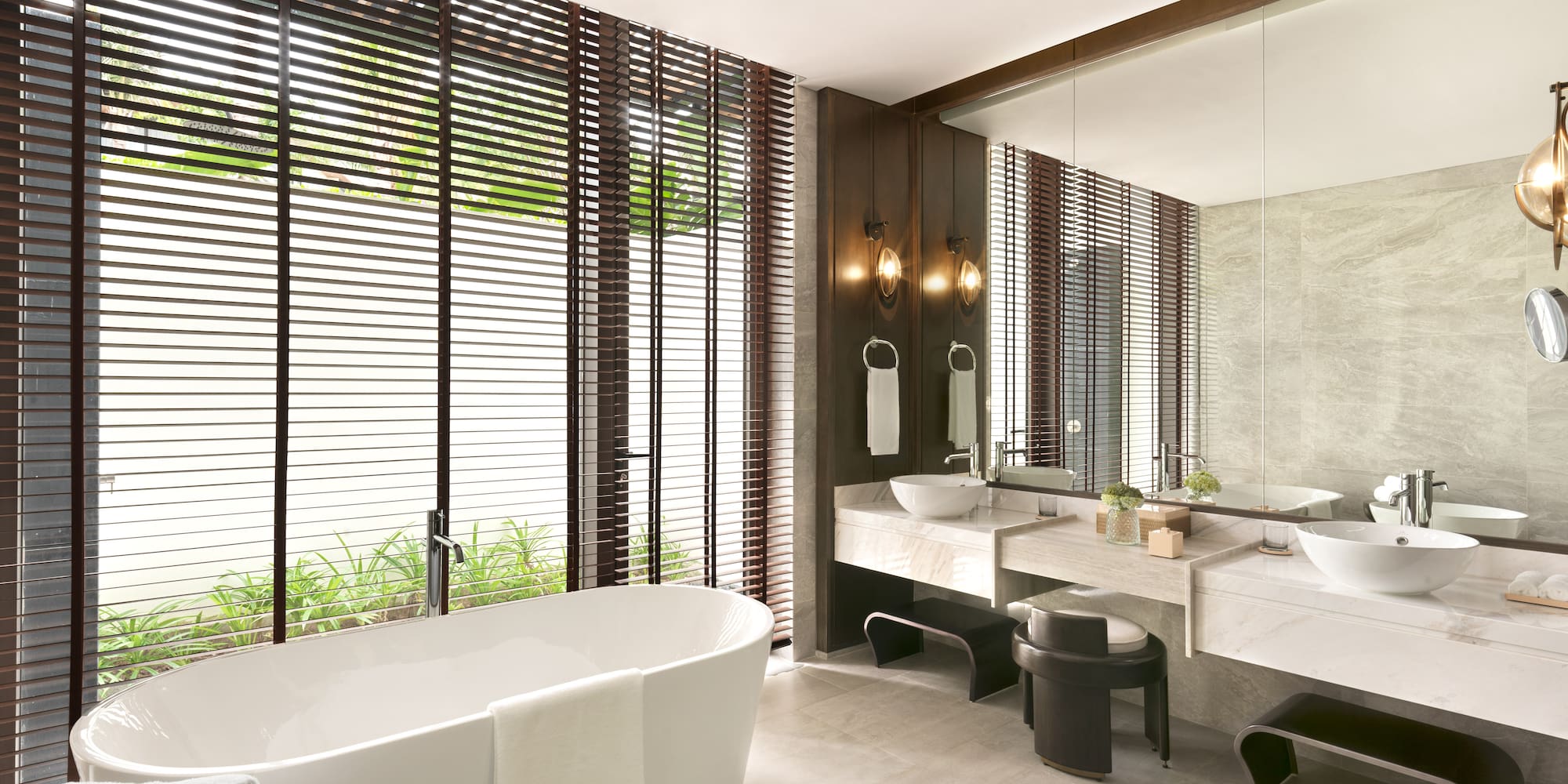 a bathroom with a tub and sinks