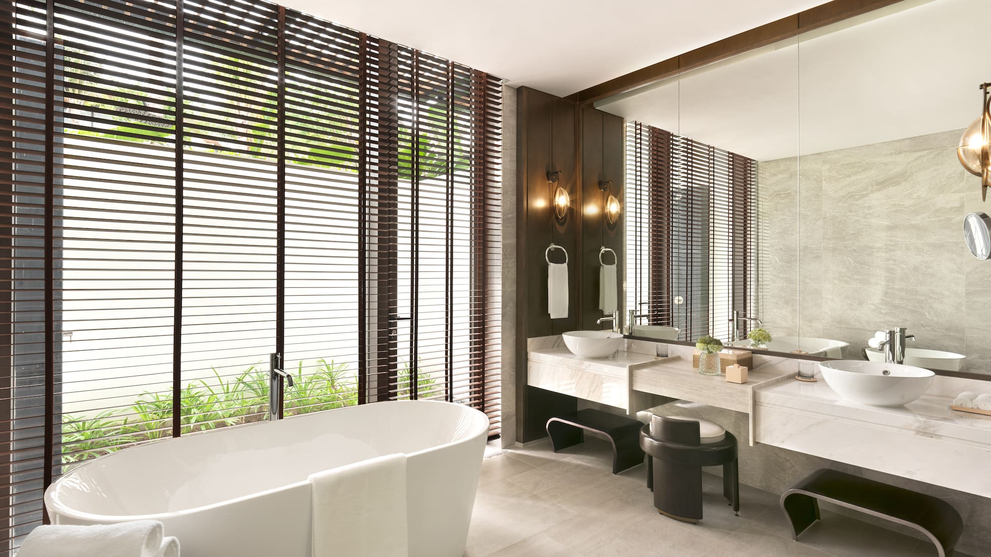 a bathroom with a tub and sinks