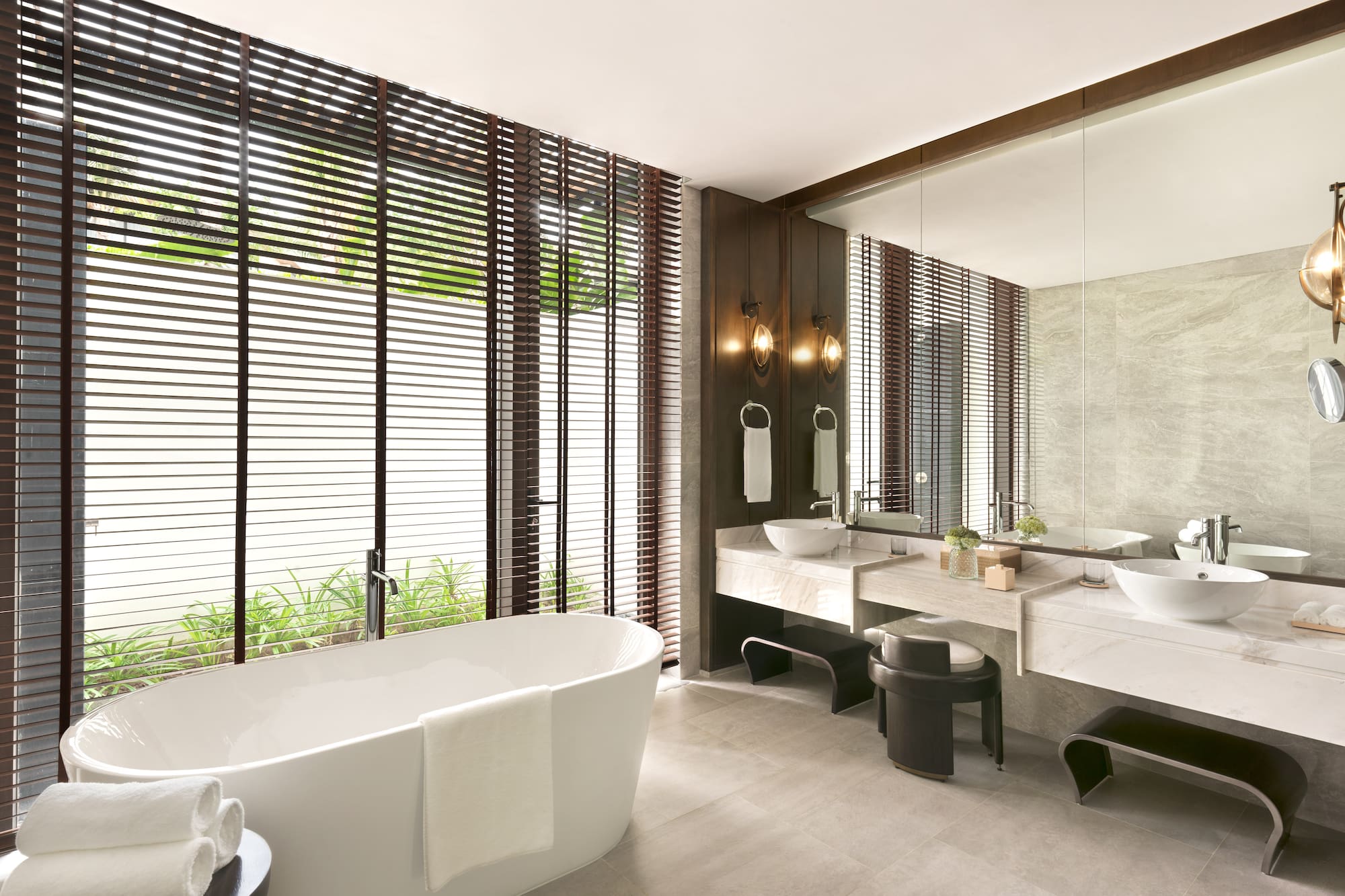 a bathroom with a tub and sinks