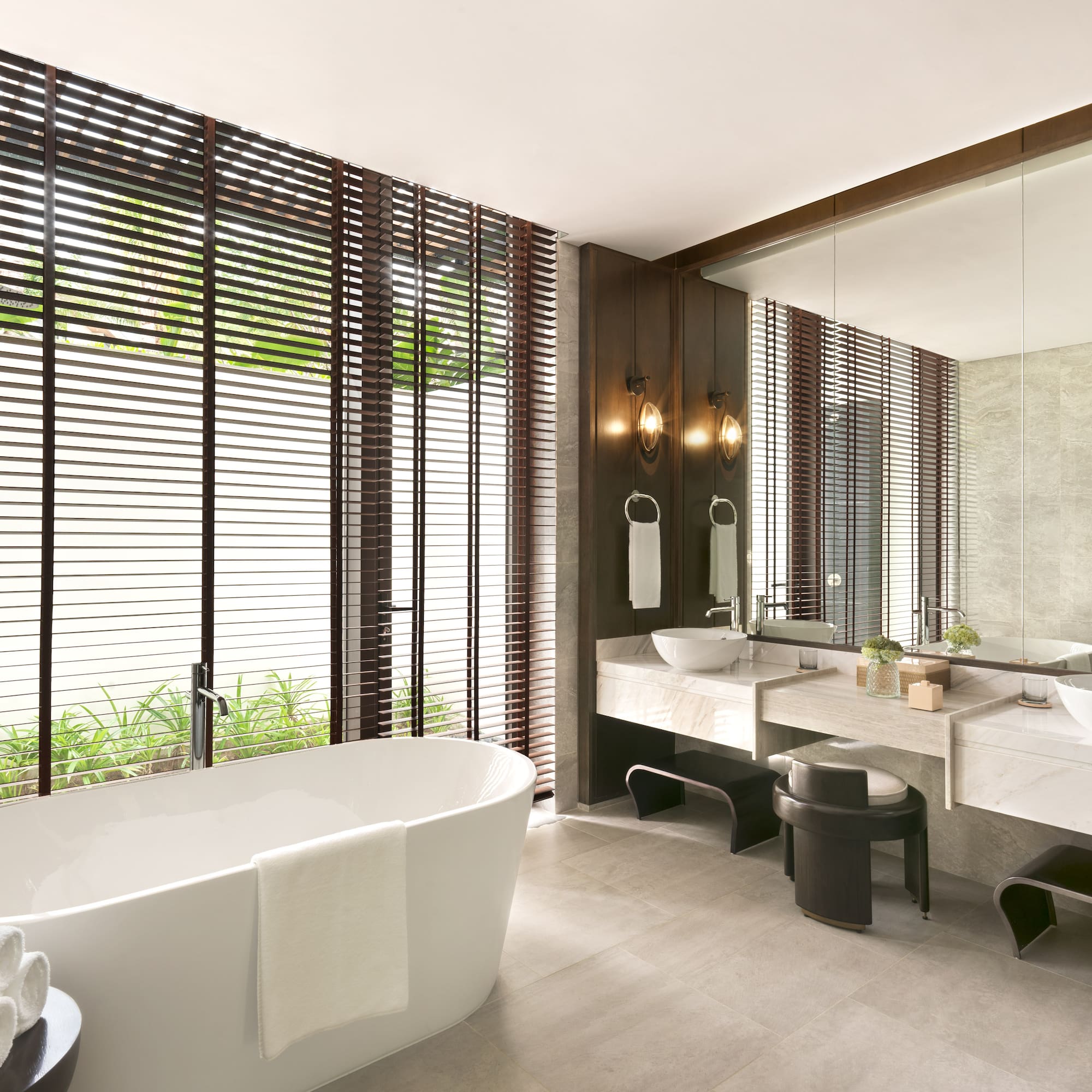 a bathroom with a tub and sinks