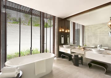 a bathroom with a tub and sinks