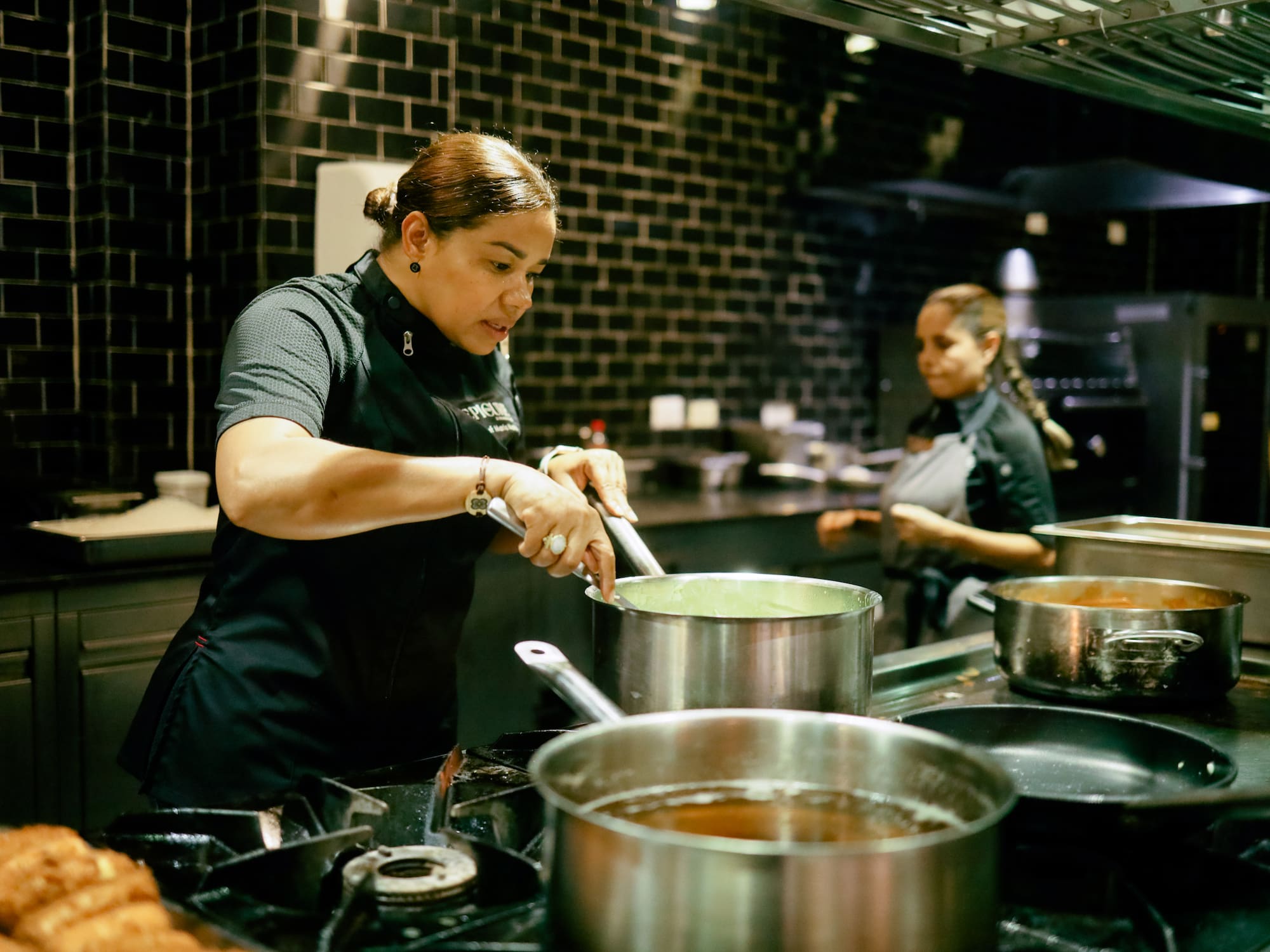 a woman cooking in a kitchen