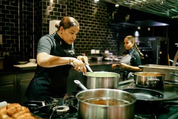 a woman cooking in a kitchen