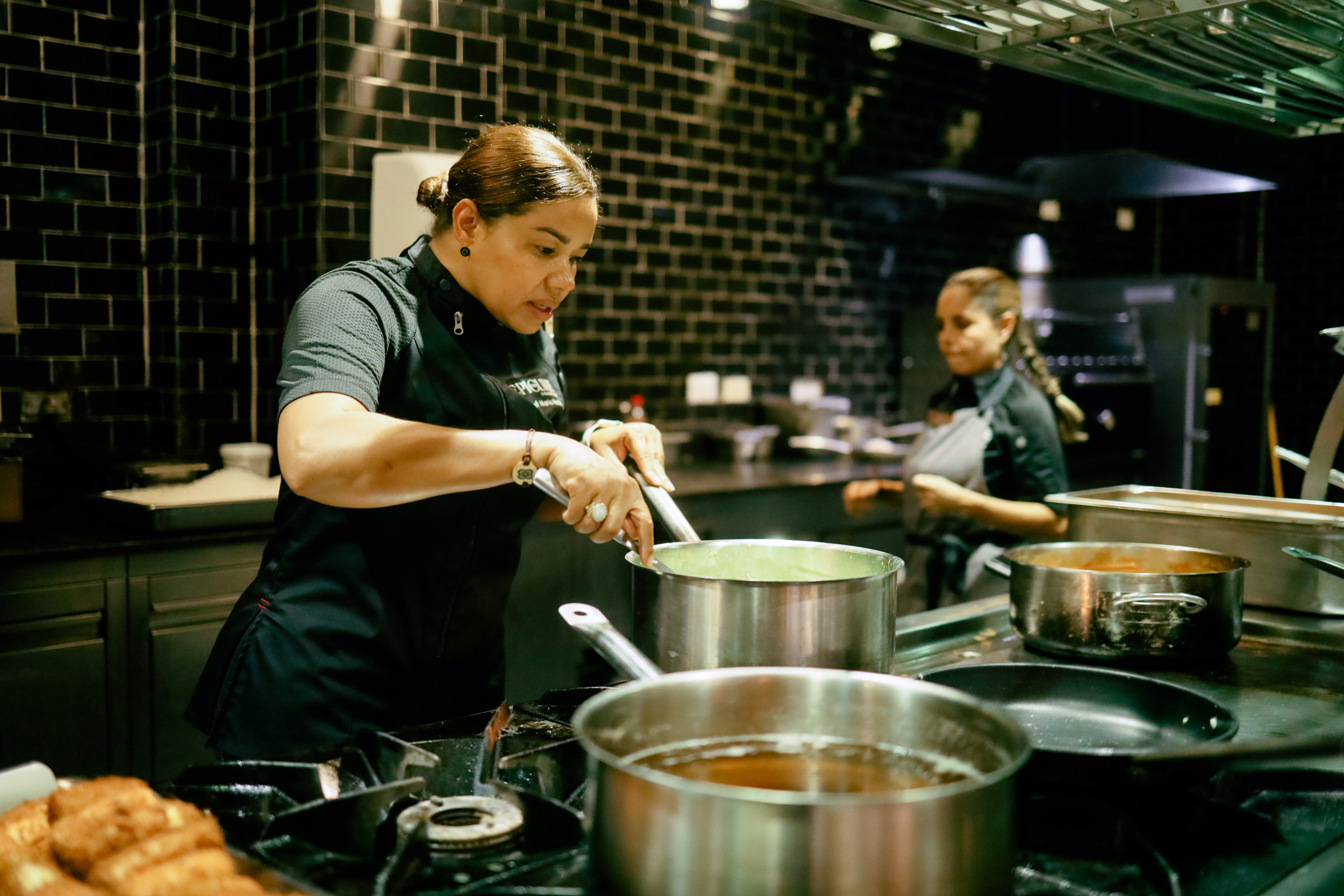 a woman cooking in a kitchen