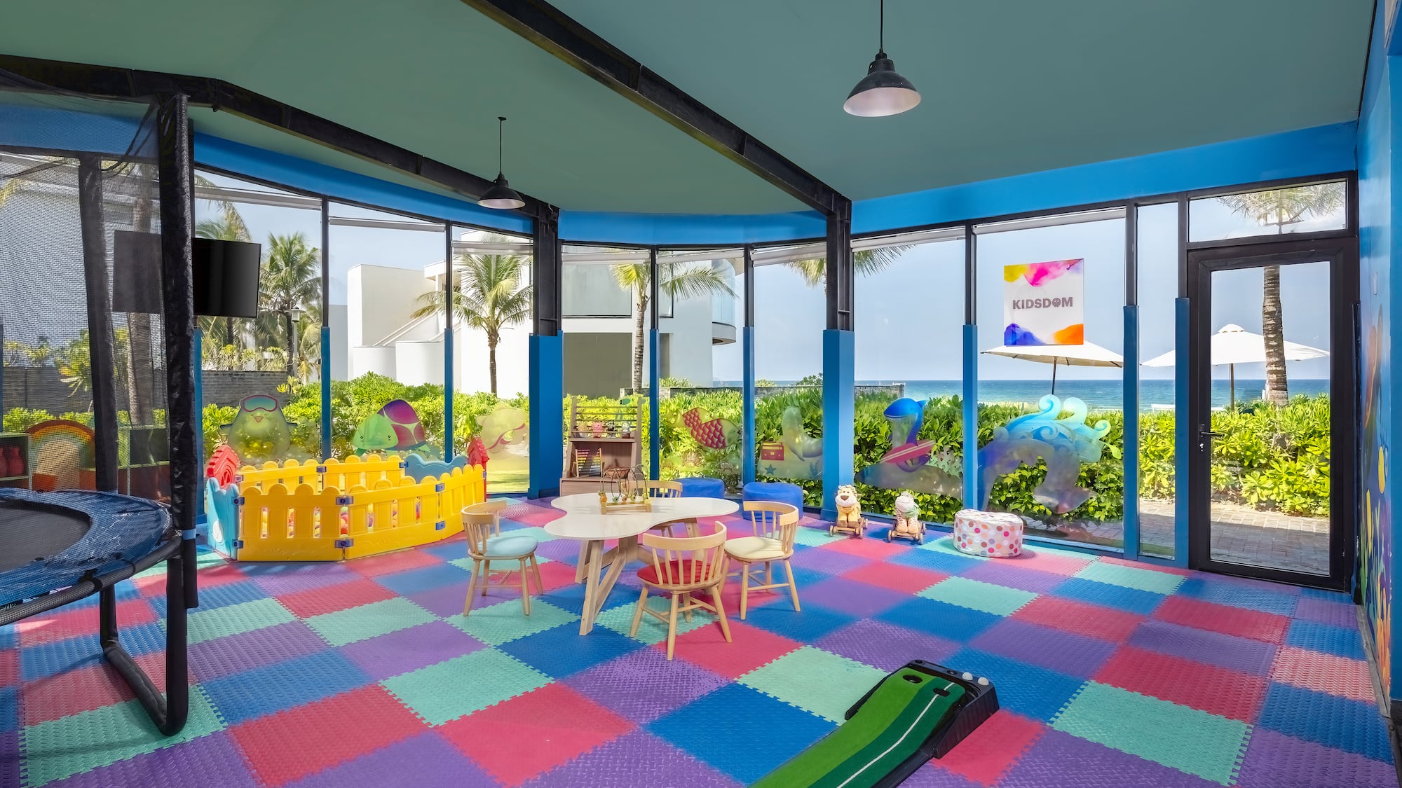 a room with a playroom with a play area and a pool