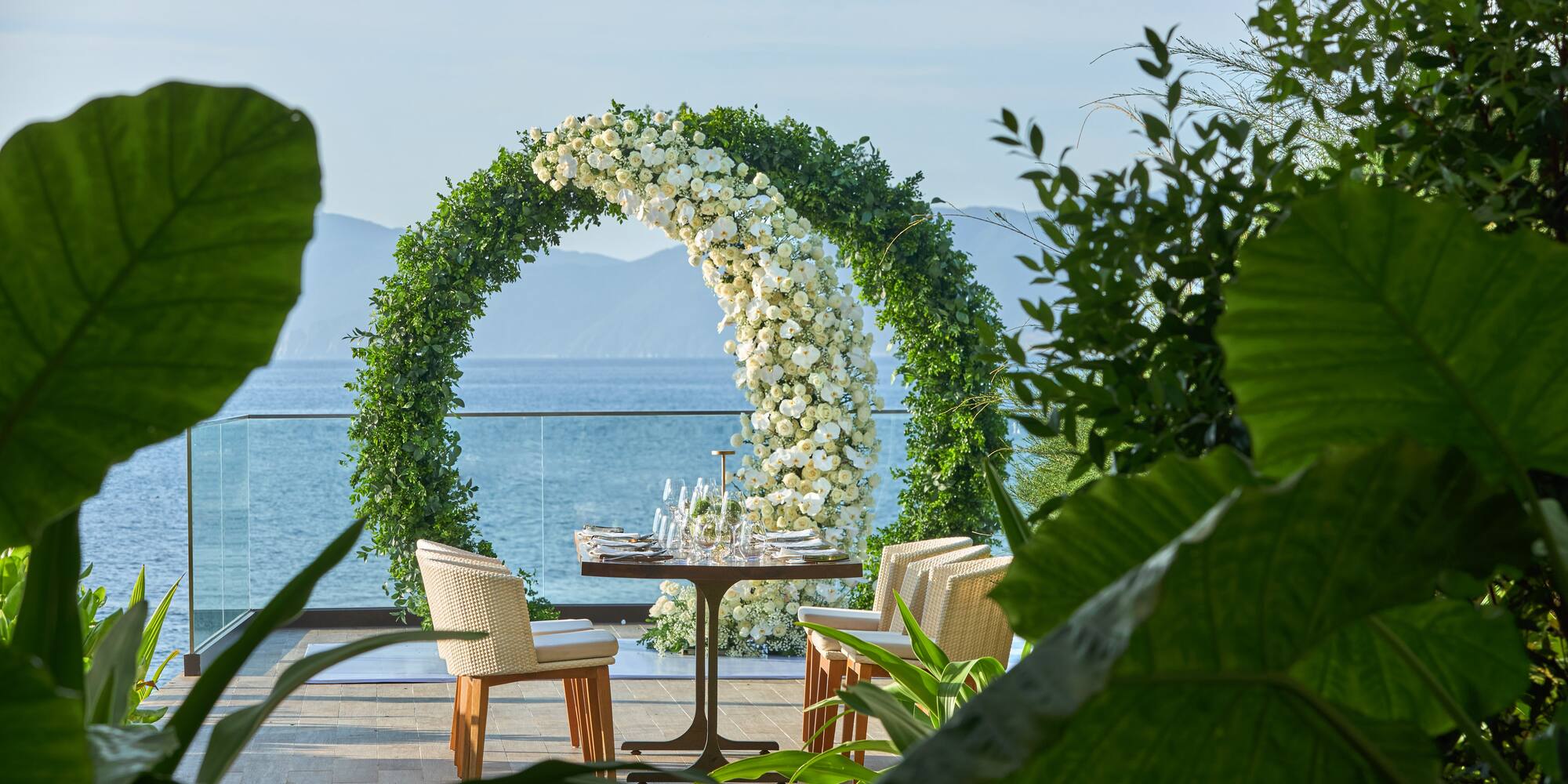 a table with chairs and a table with flowers around it