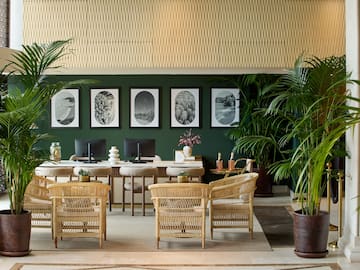 a room with a desk and chairs and a computer