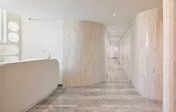 a hallway with marble walls and a reception desk