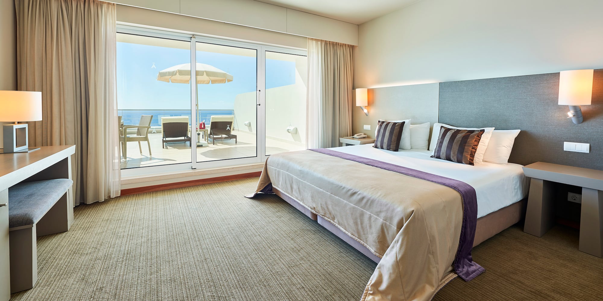 a bedroom with a large bed and a glass door