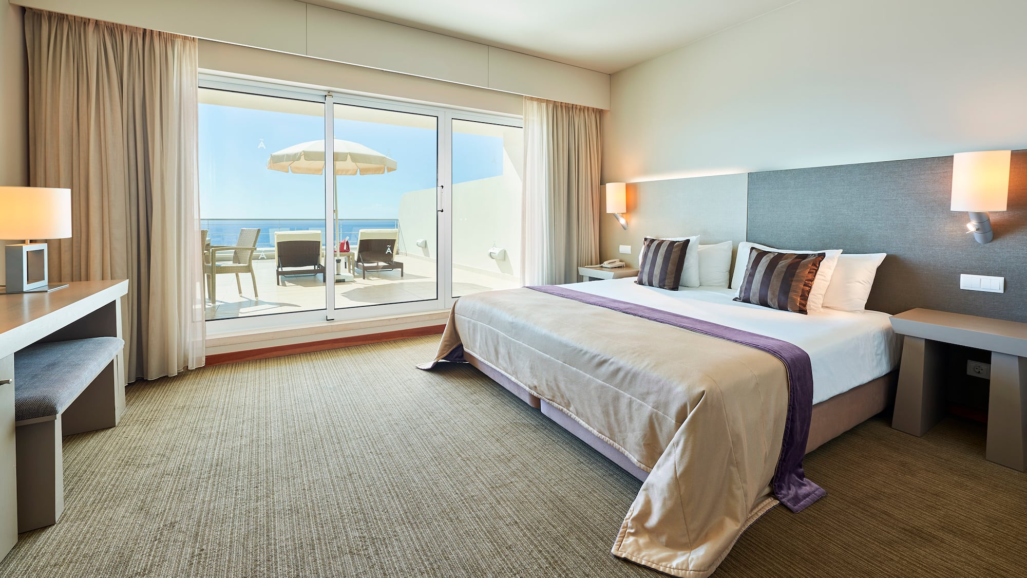 a bedroom with a large bed and a glass door