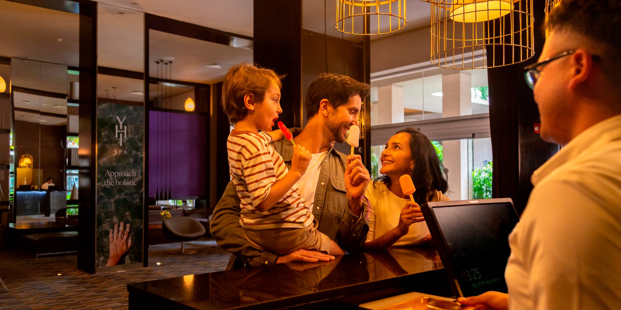 a man and woman holding popsicles and smiling at a counter