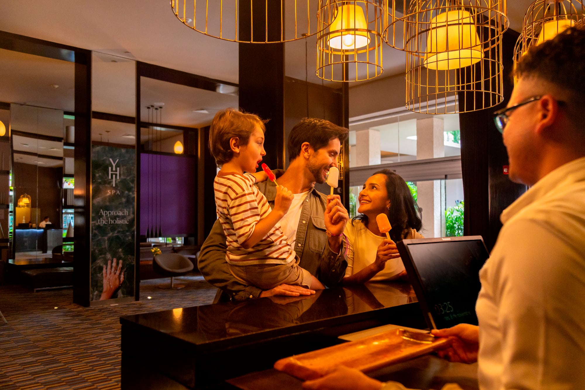 a man and woman holding popsicles and smiling at a counter