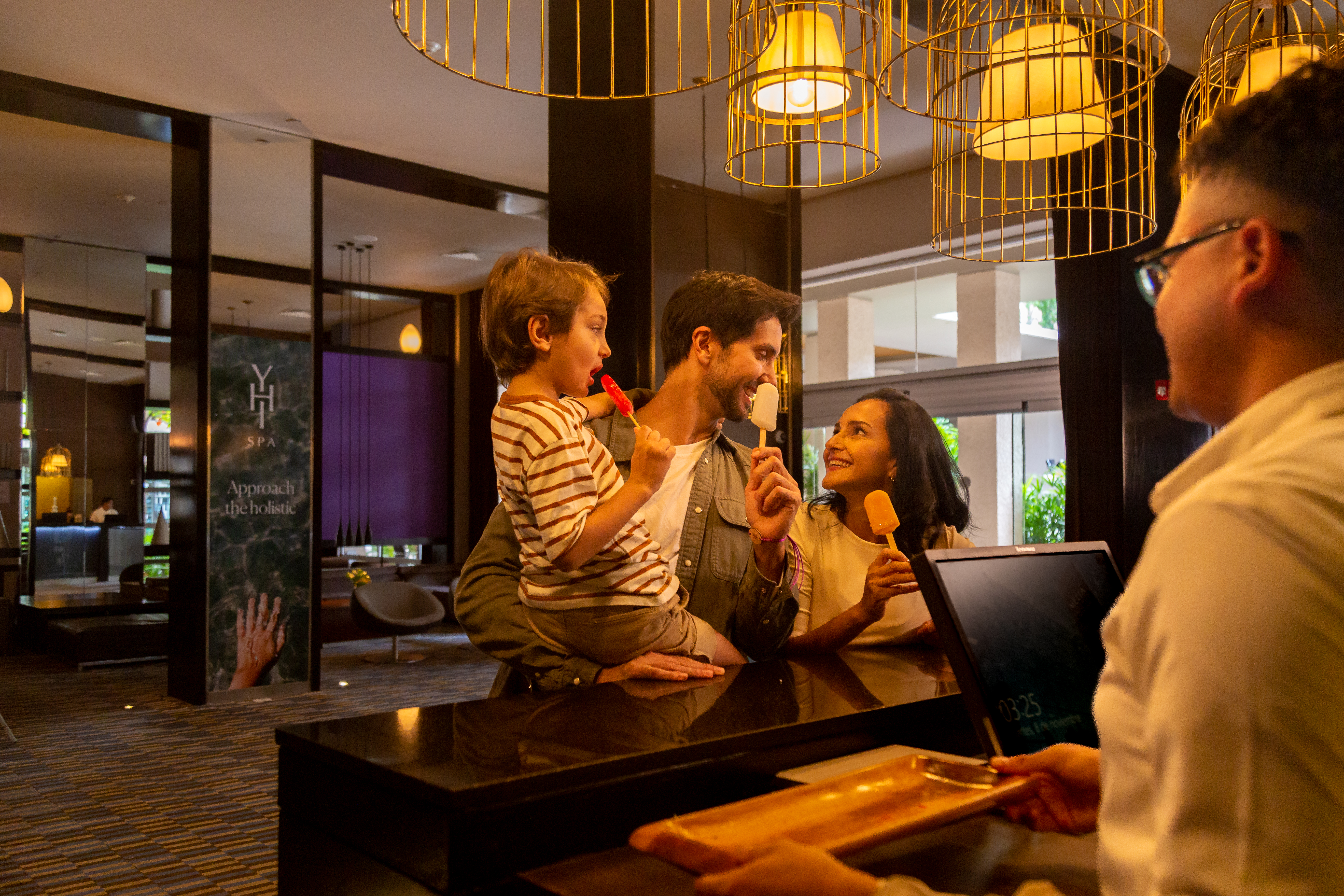 a man and woman holding popsicles and smiling at a counter