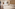 Modern hotel room with two beds, hardwood floor, TV, and ambient lighting.
