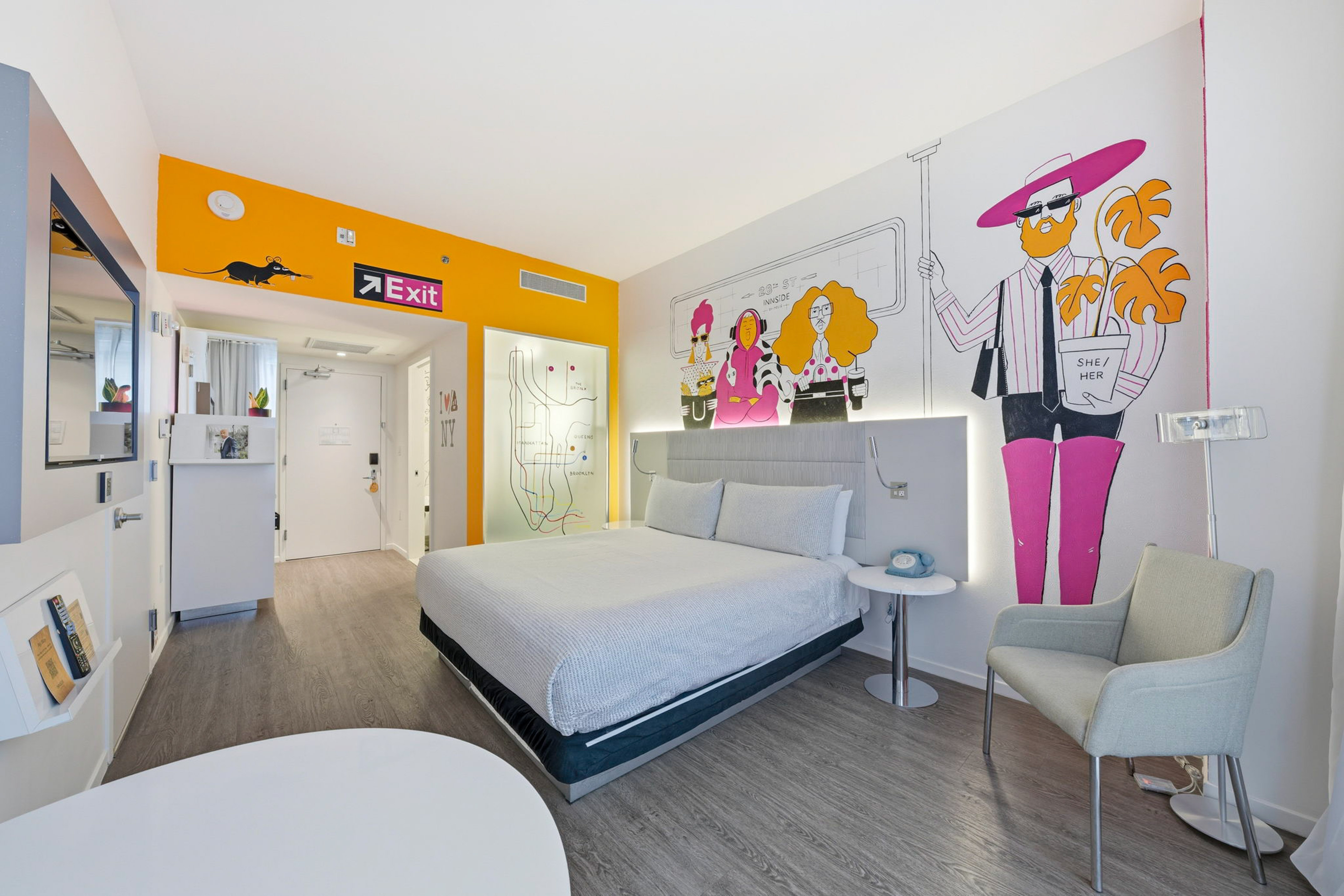 a room with a bed and chairs