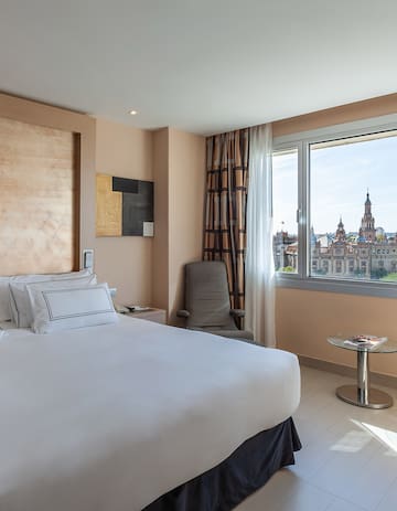 a bedroom with a large bed and a window