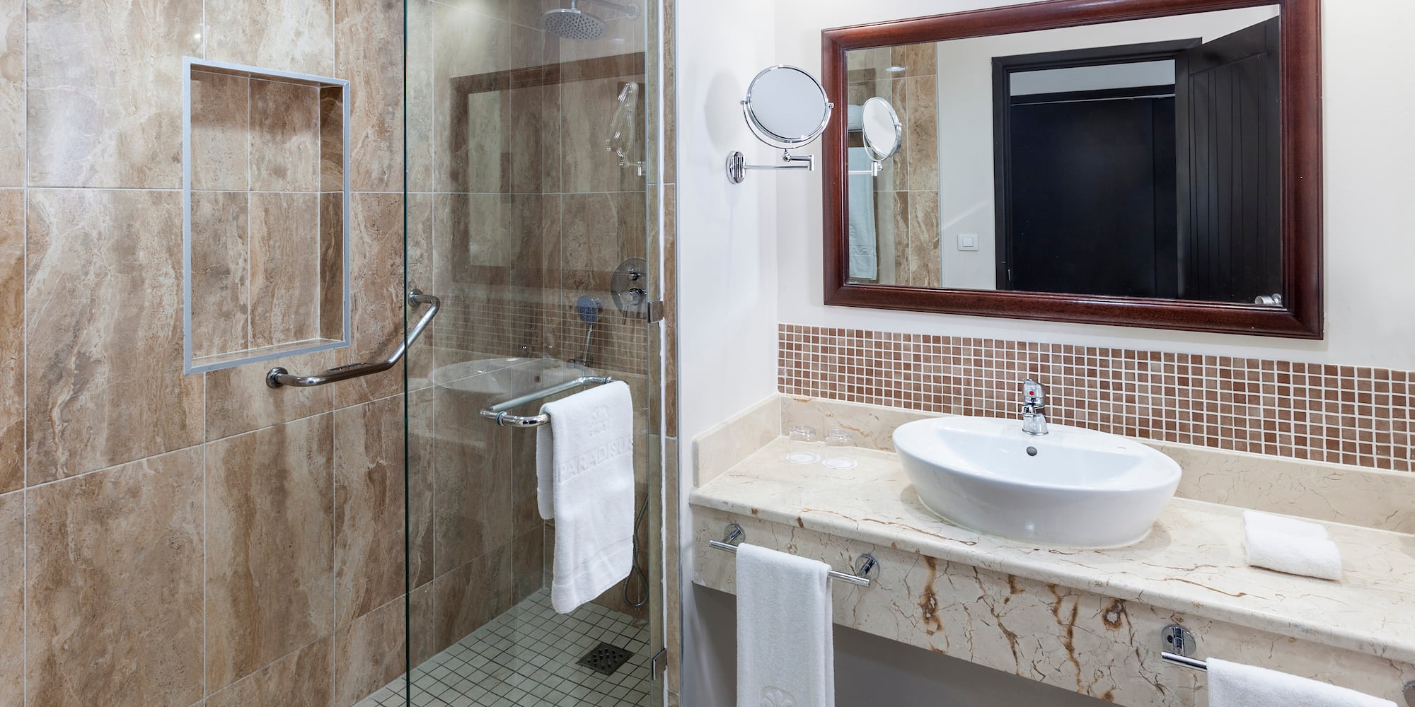 a bathroom with a glass shower and sink