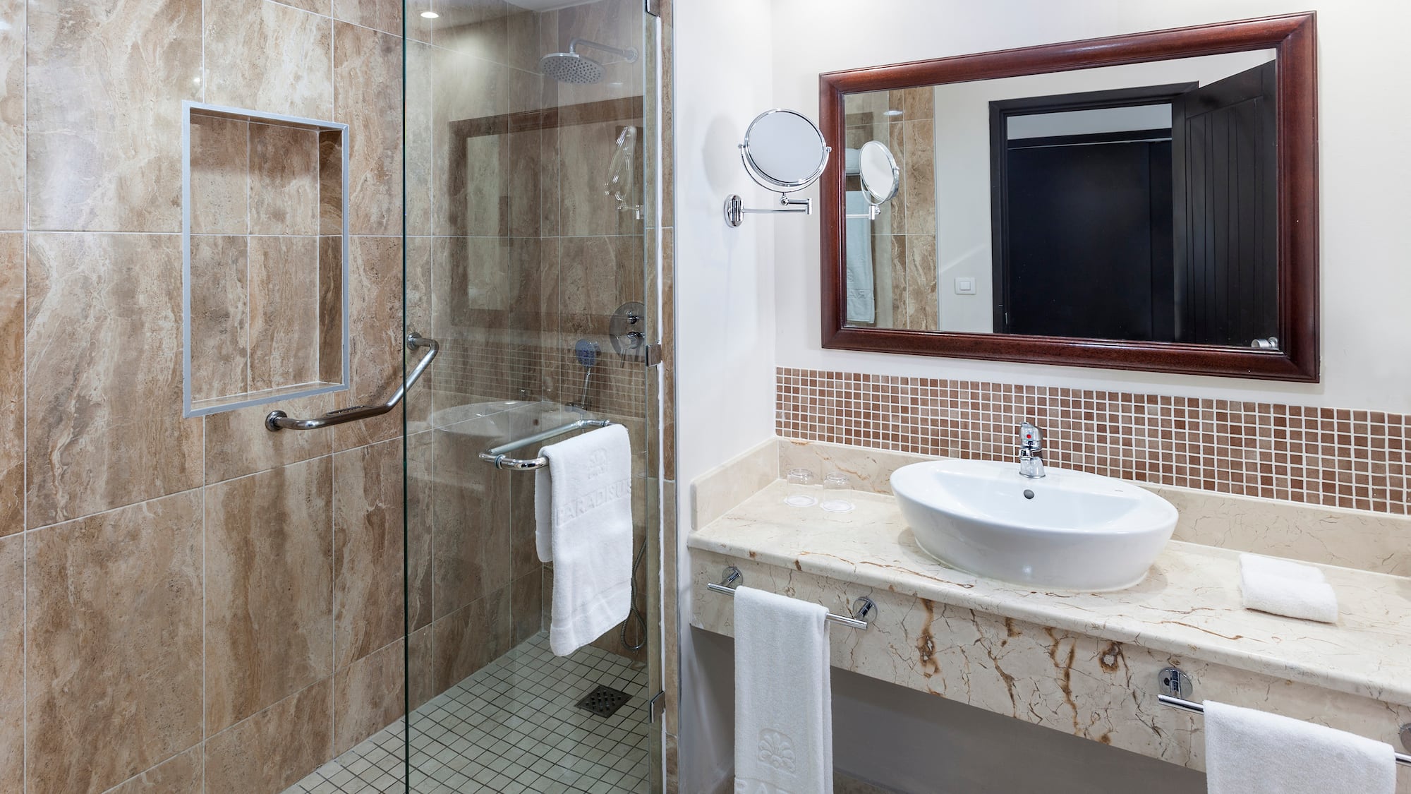 a bathroom with a glass shower and sink