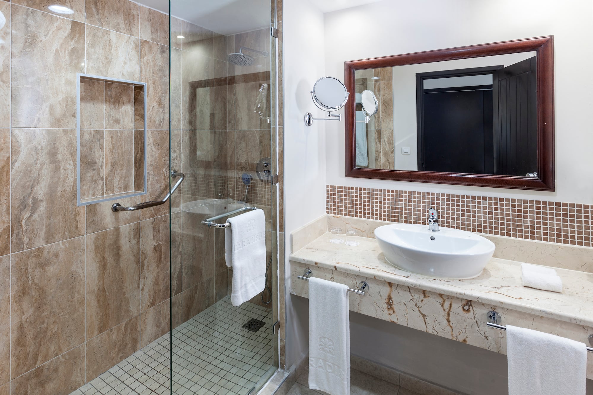 a bathroom with a glass shower and sink