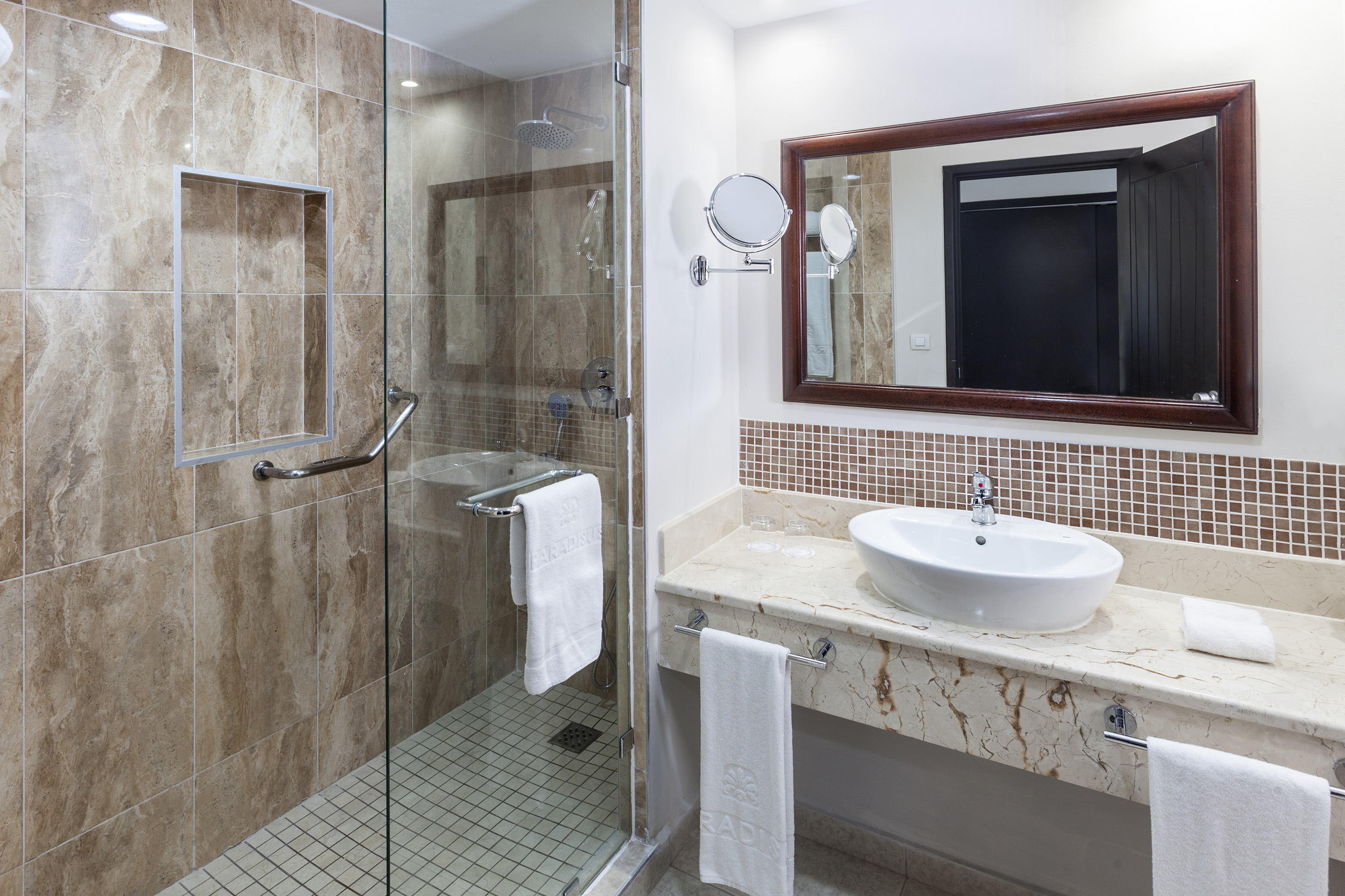 a bathroom with a glass shower and sink