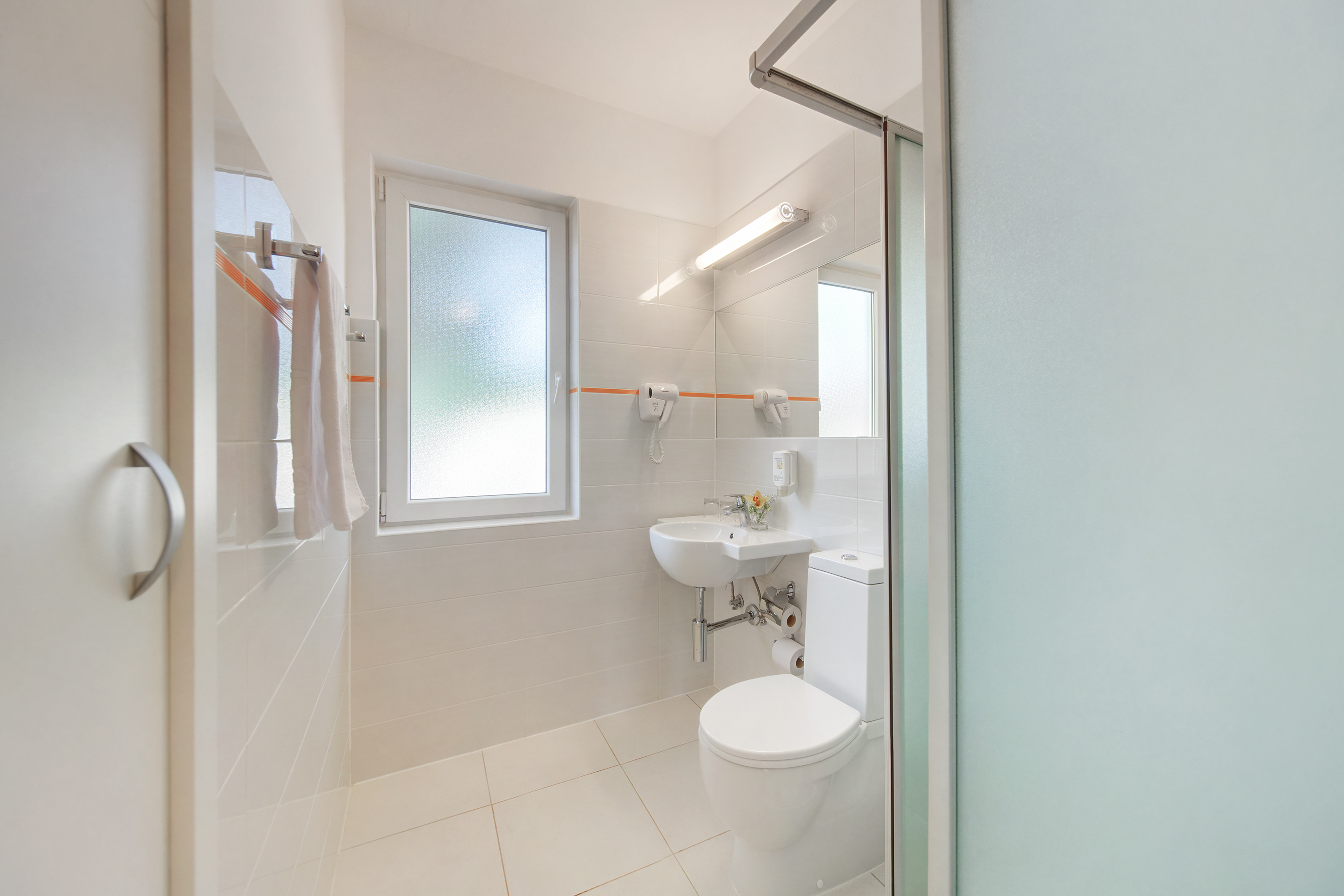 a bathroom with a shower and toilet