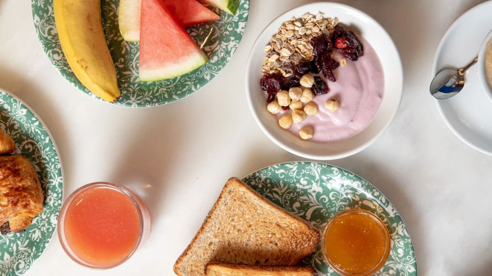 a table with plates of food and drinks