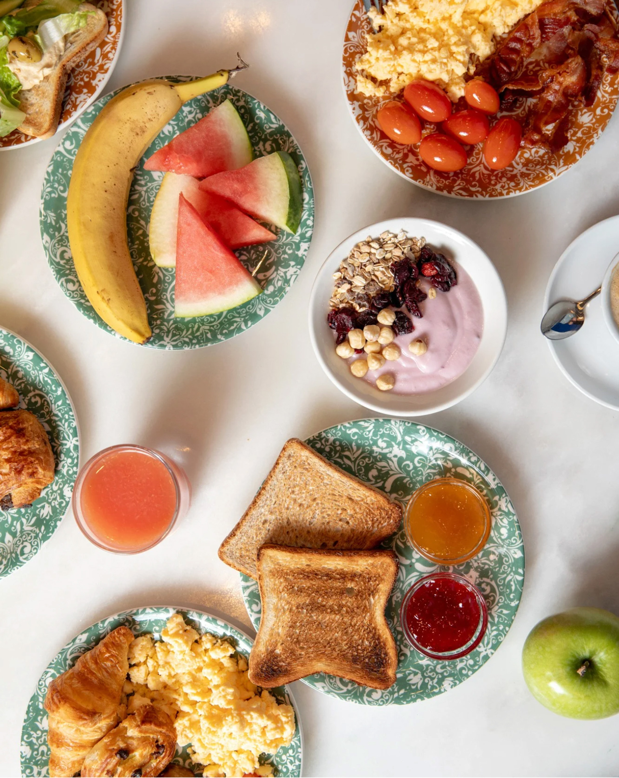a table with plates of food and drinks