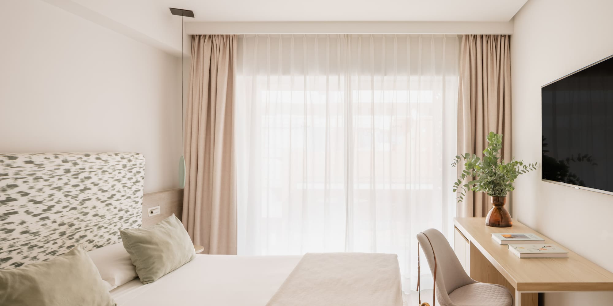 a bedroom with a desk and a bed