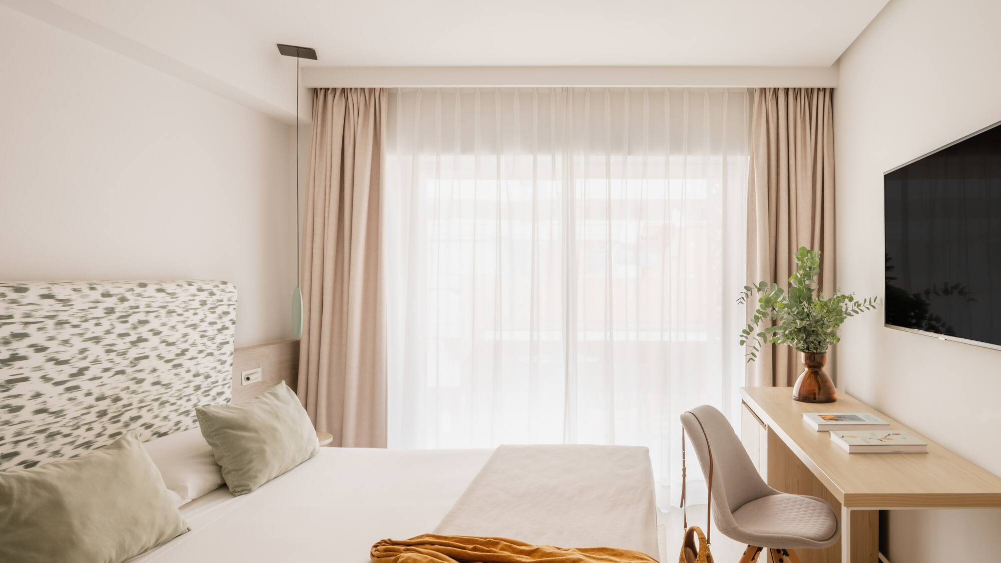 a bedroom with a desk and a bed