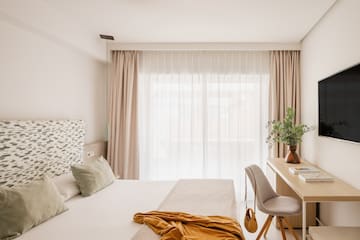 a bedroom with a desk and a bed