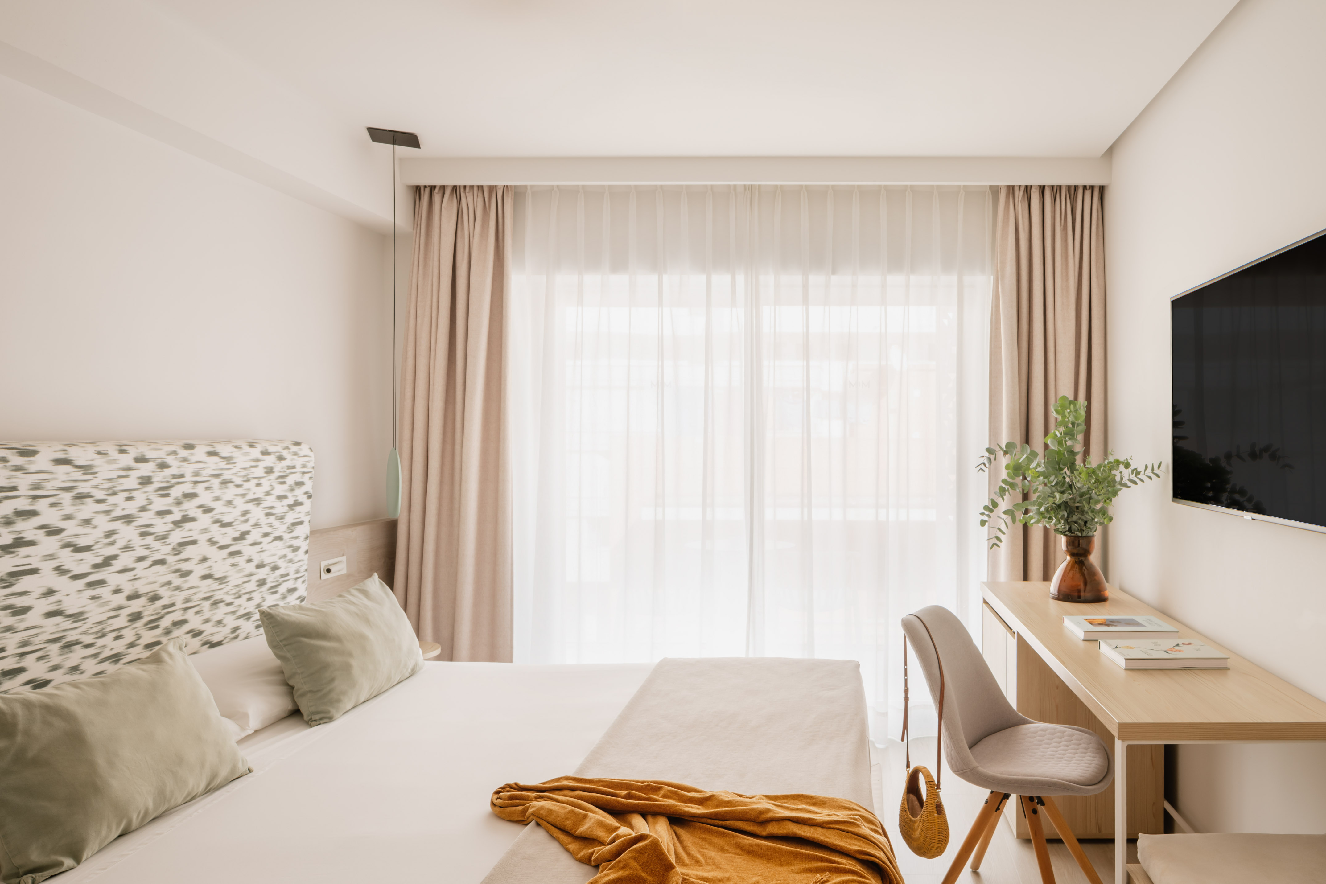 a bedroom with a desk and a bed