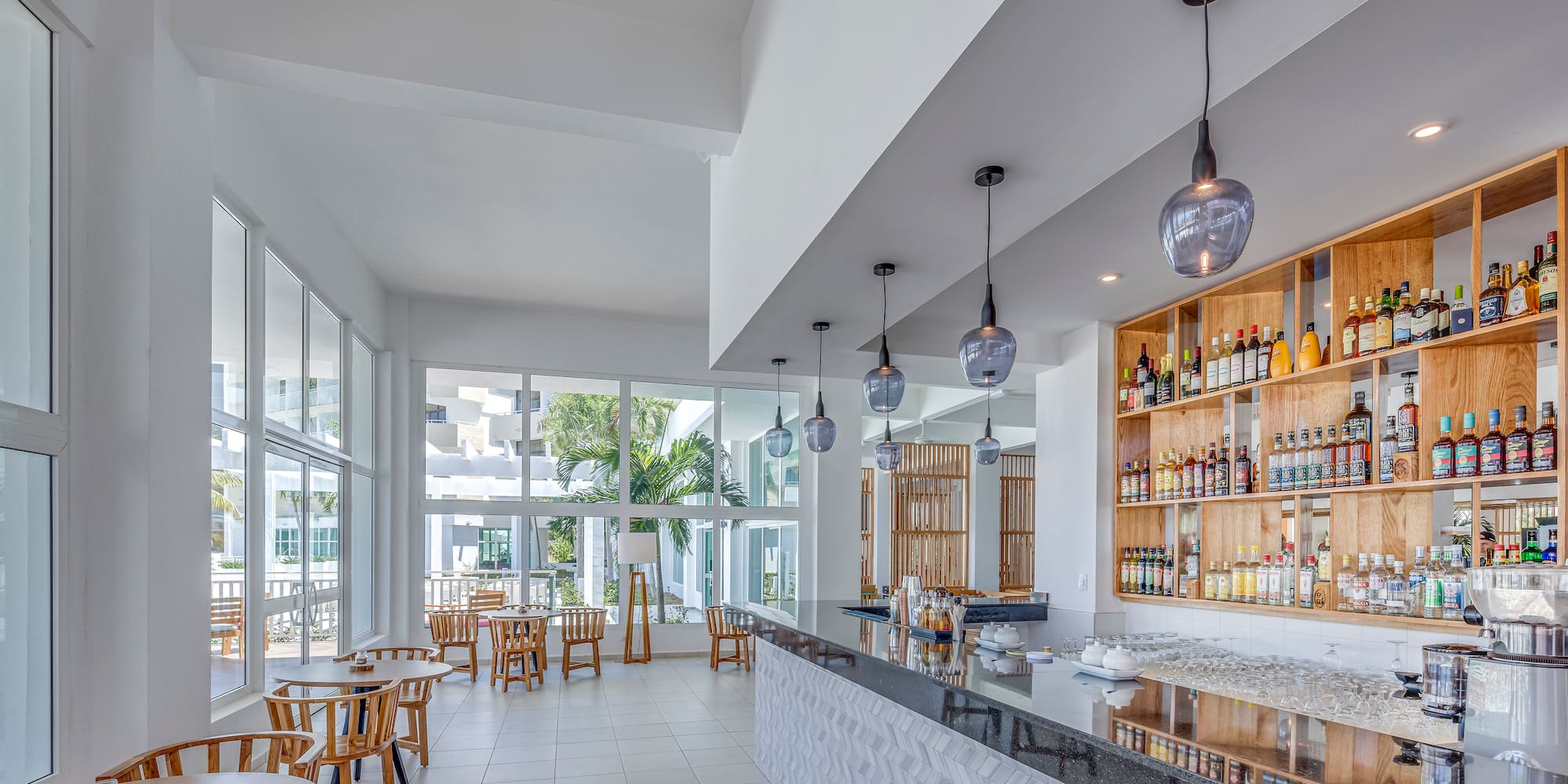 a room with a bar and tables and chairs
