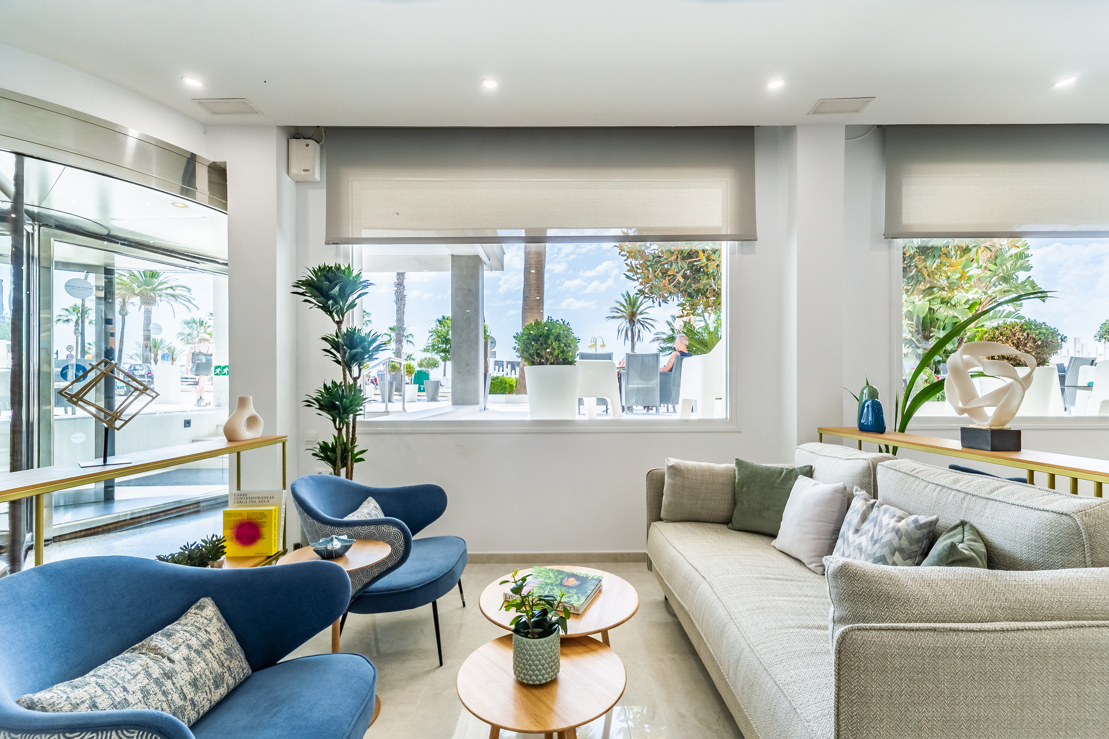 a room with a couch and chairs