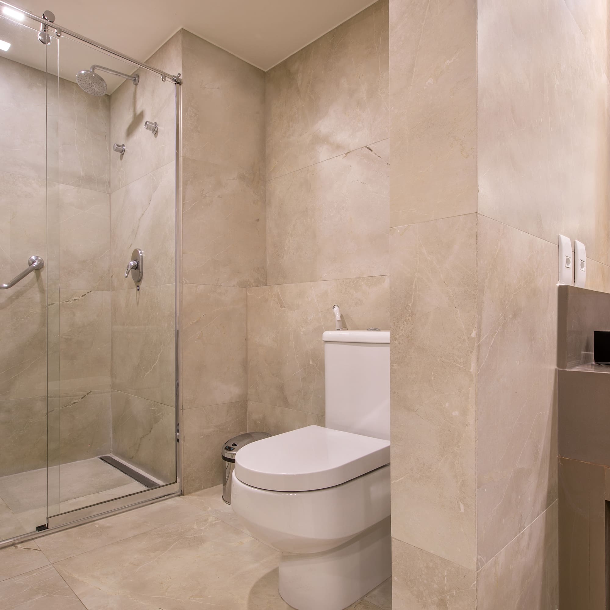 a bathroom with a glass shower door