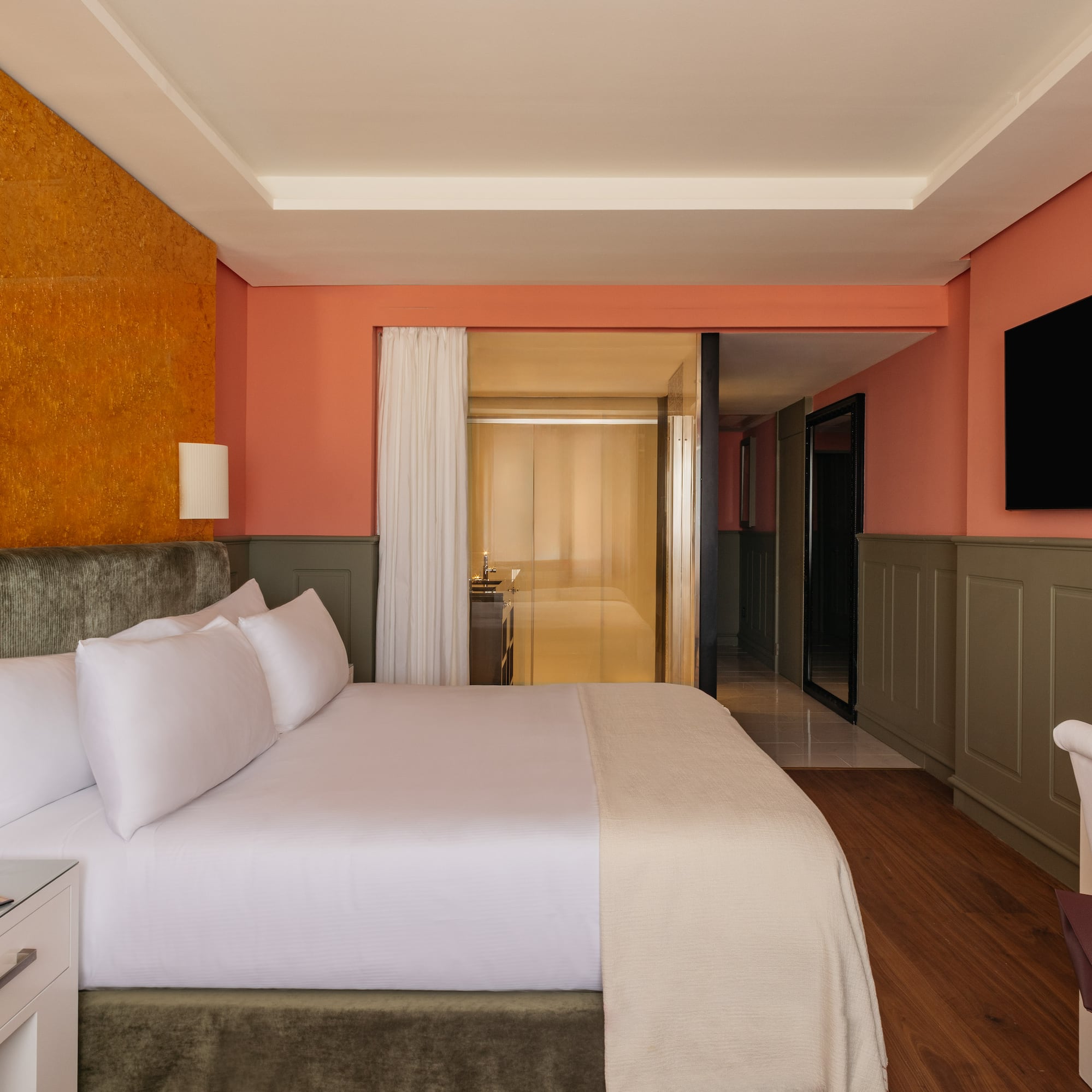 a room with a bed and a television