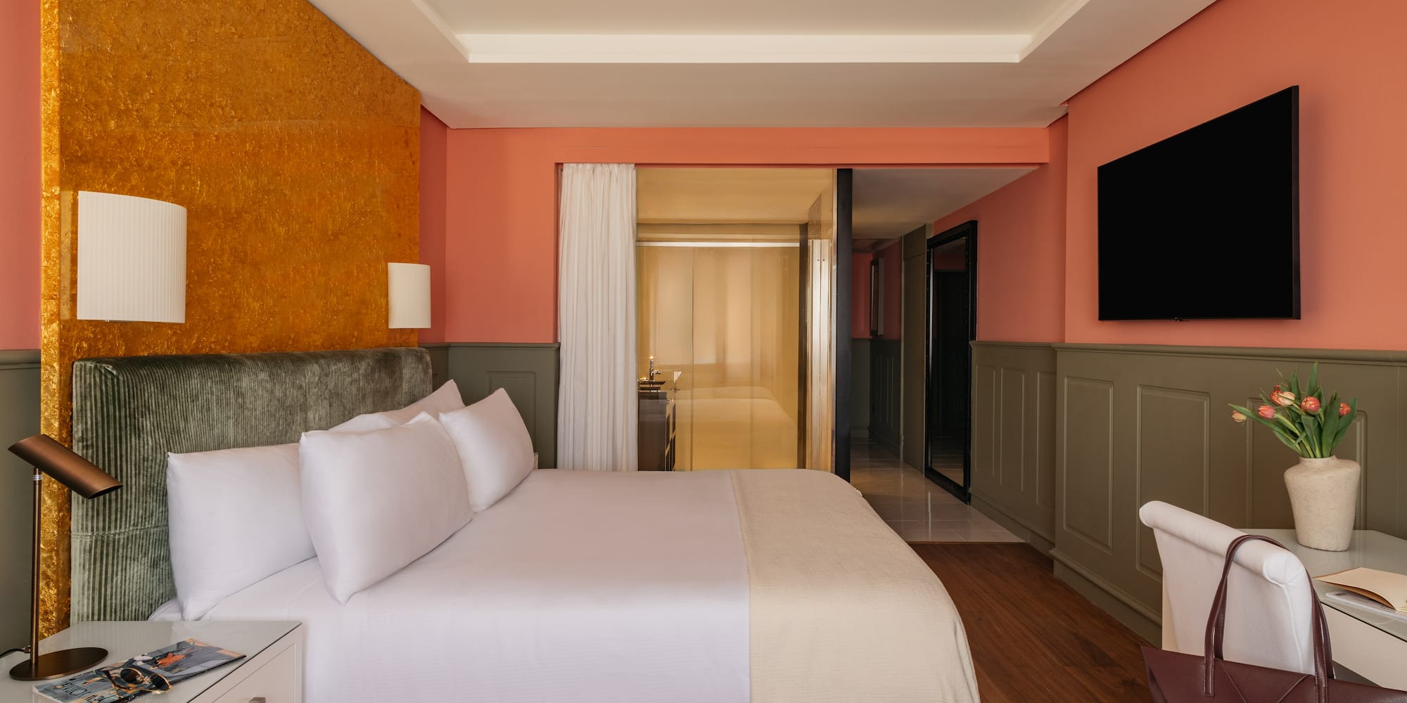 a room with a bed and a television