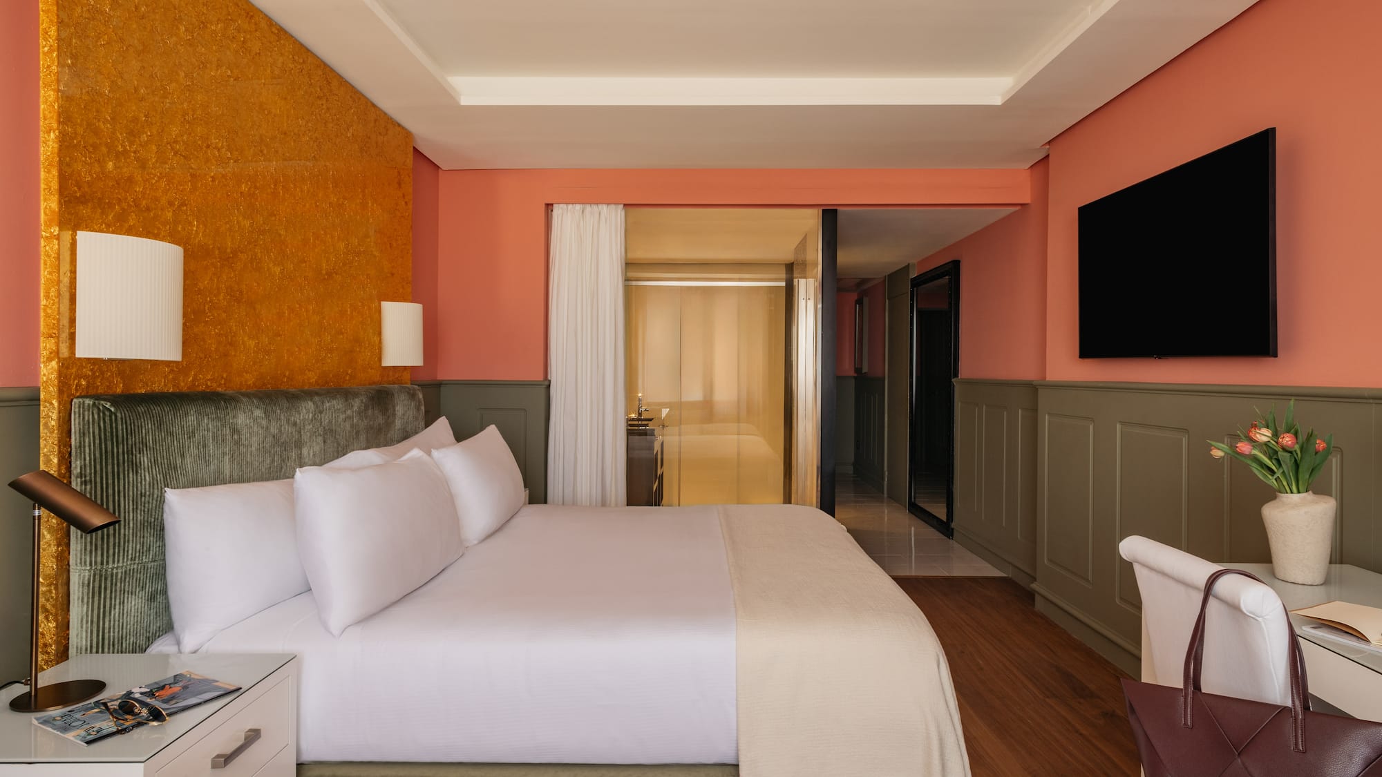 a room with a bed and a television