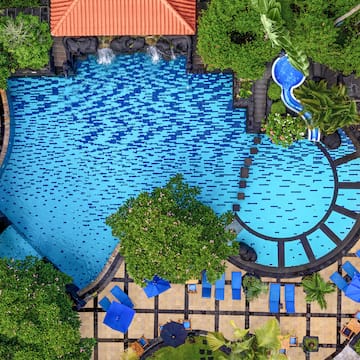 a swimming pool with trees and a pool