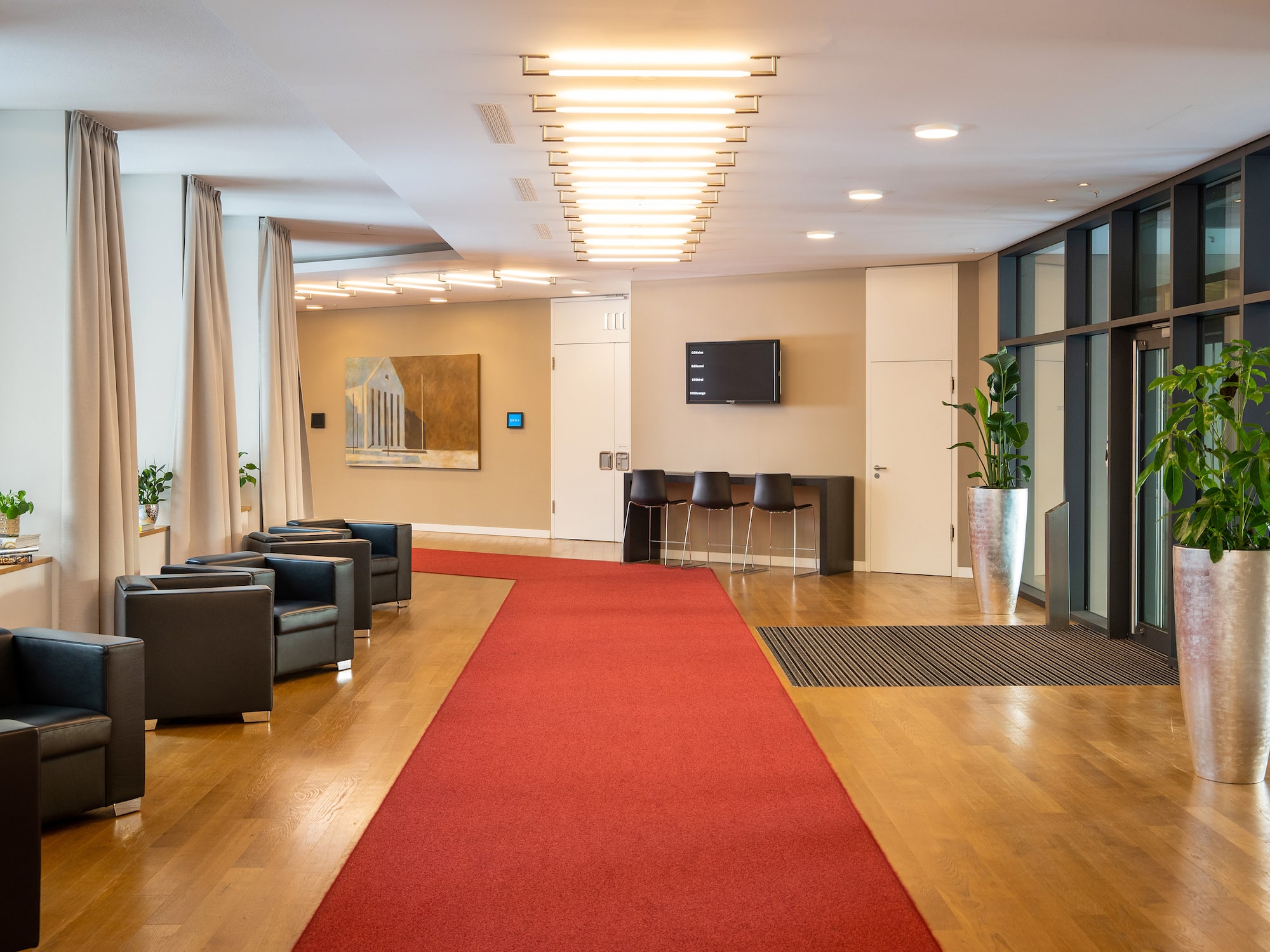 a room with chairs and a red carpet