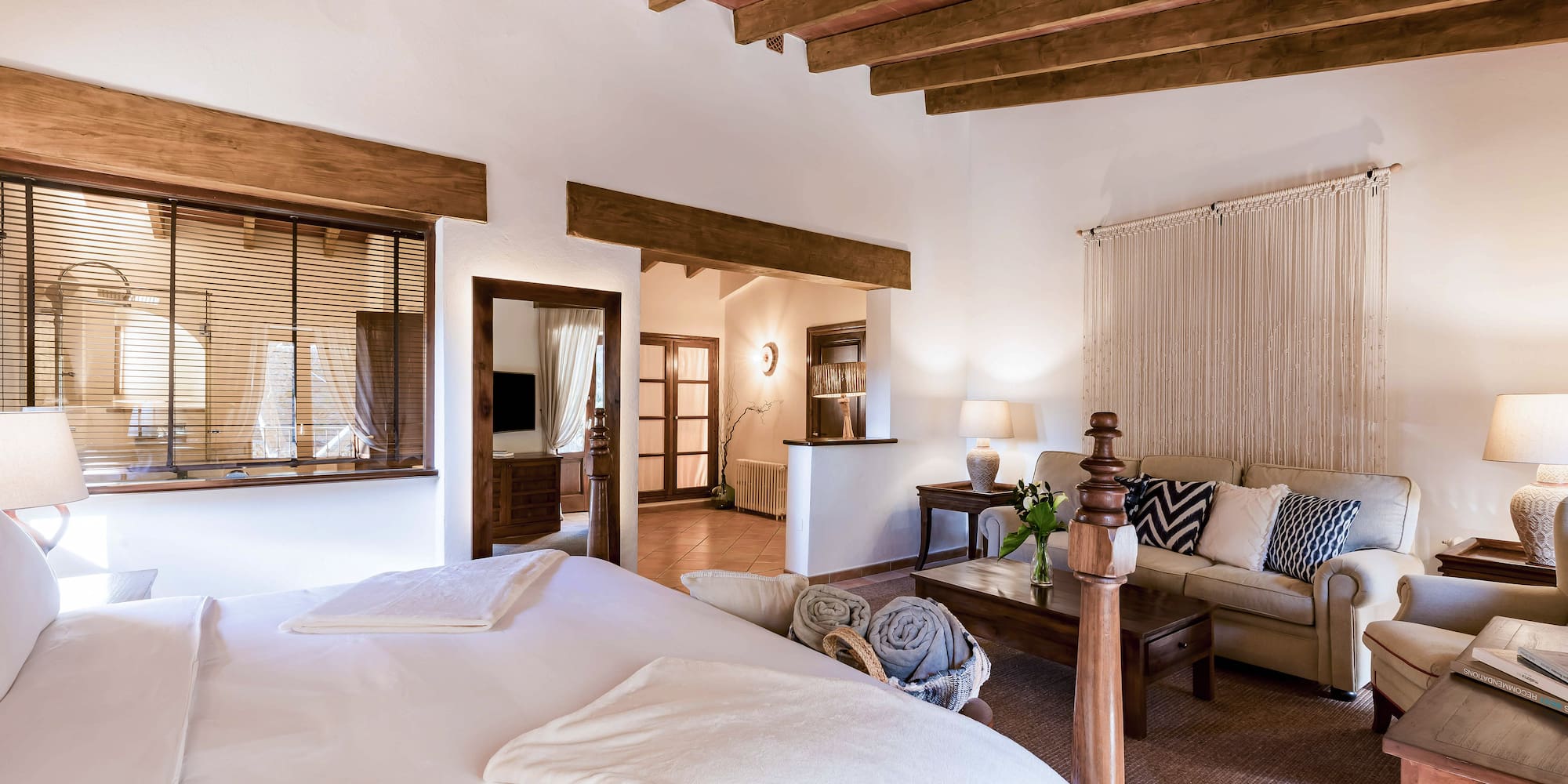 a bedroom with a couch and a bed