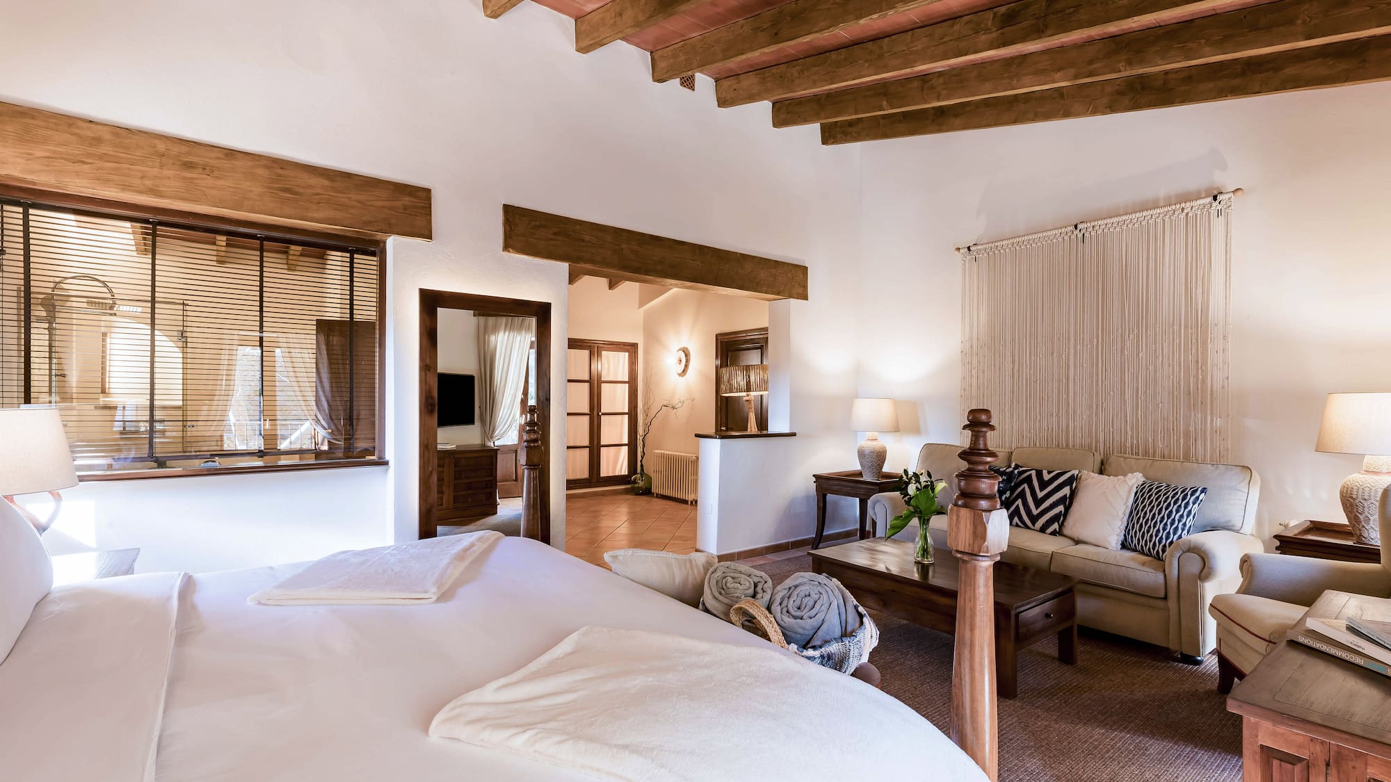 a bedroom with a couch and a bed