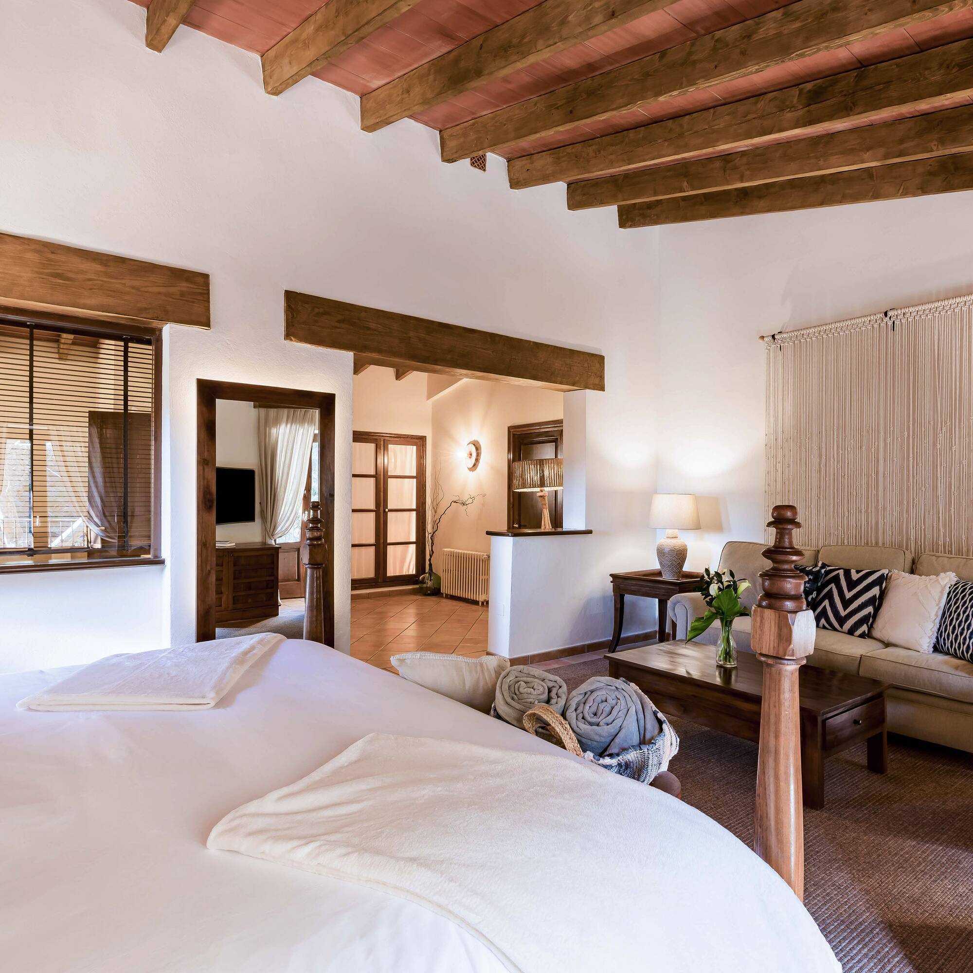 a bedroom with a couch and a bed